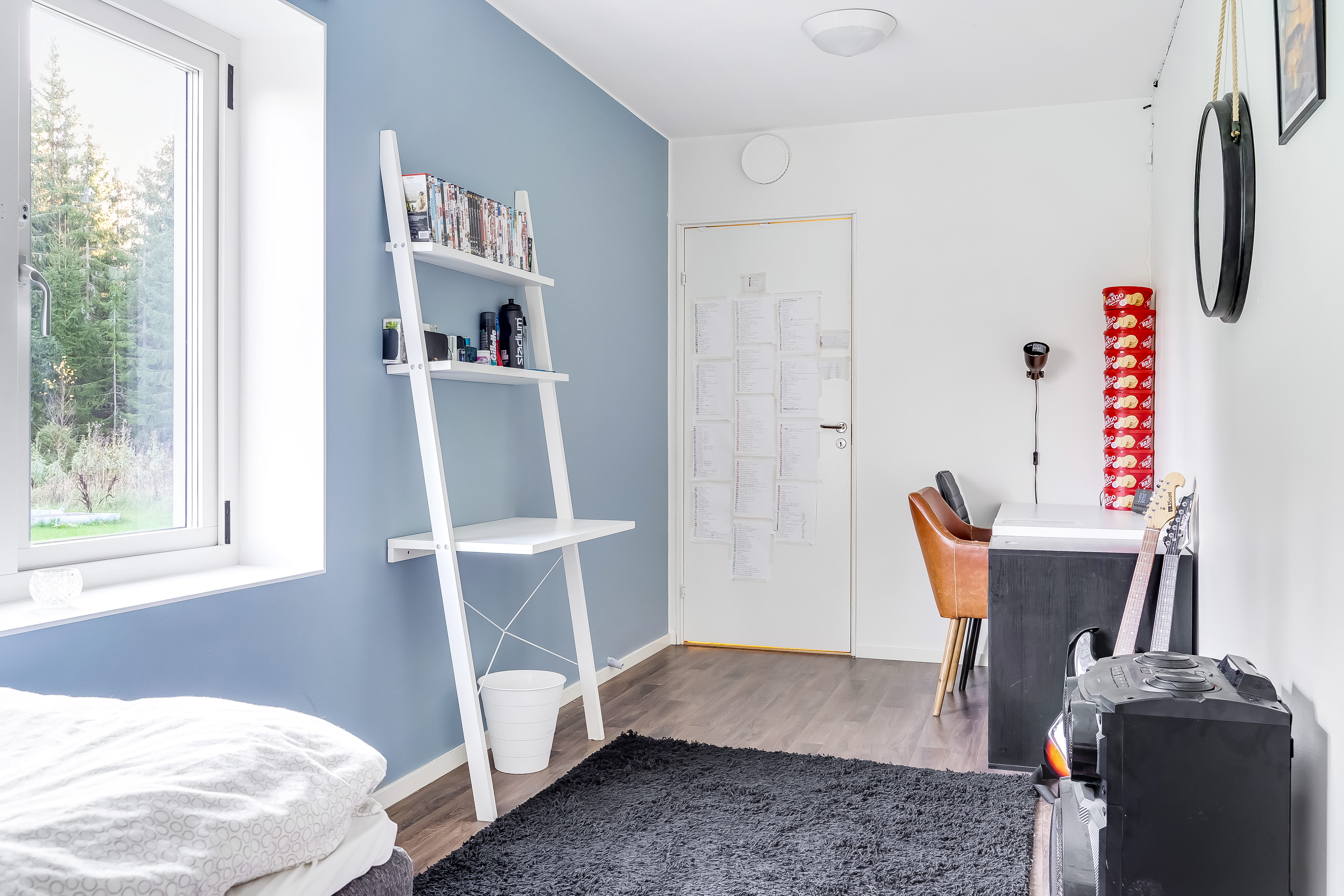 A bedroom with a bed and a window