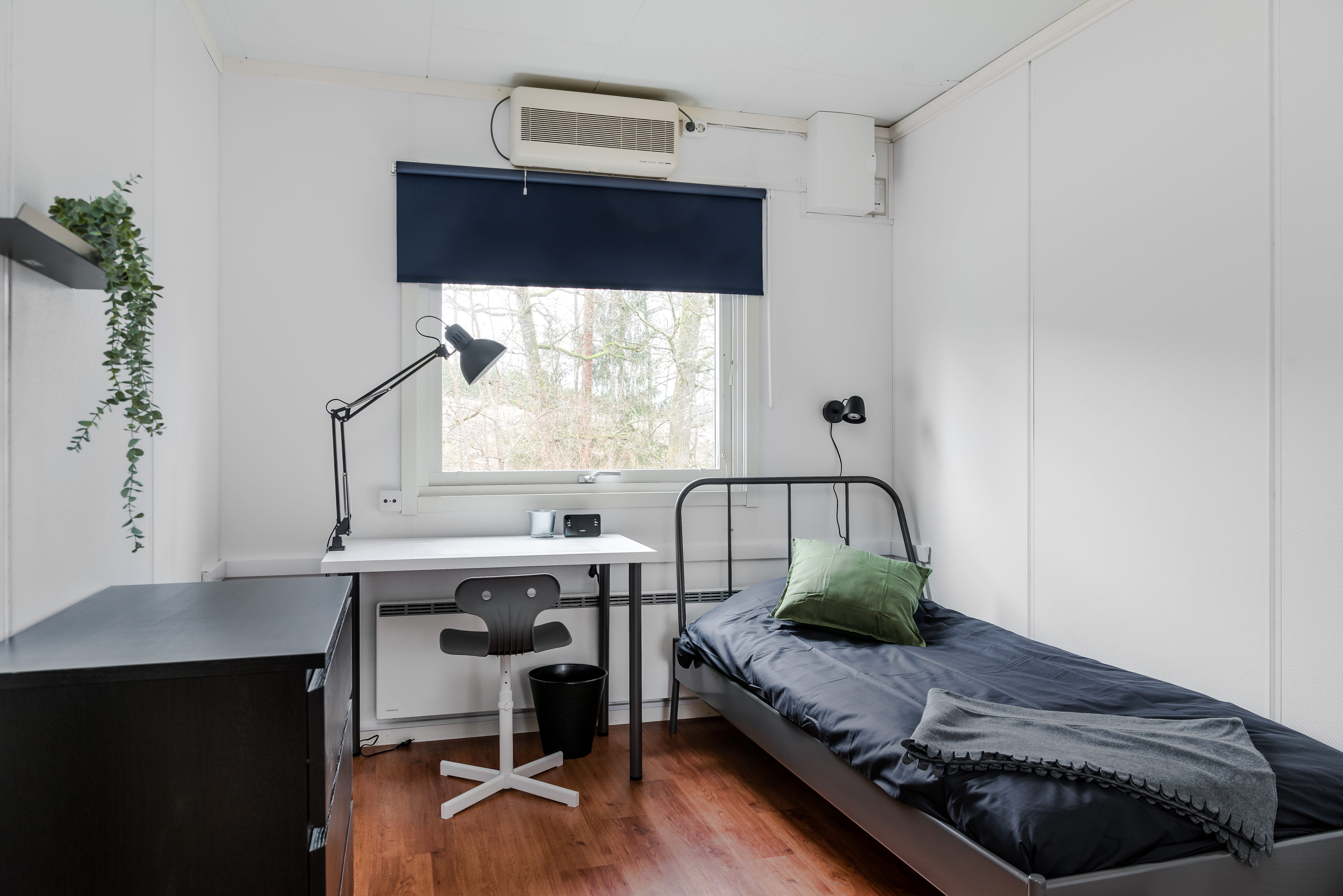 A bedroom with a bed in a room