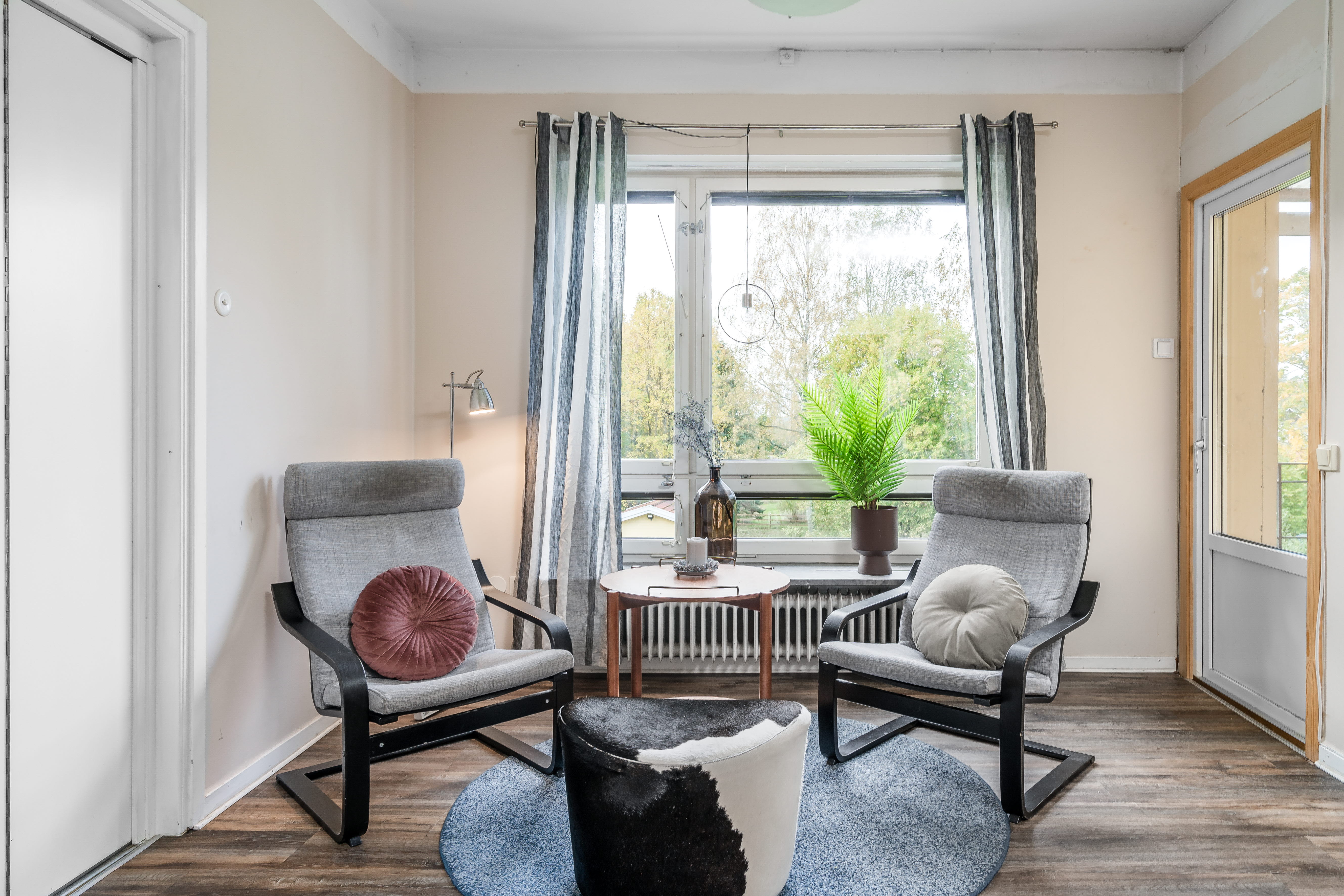 A living room filled with furniture and a large window