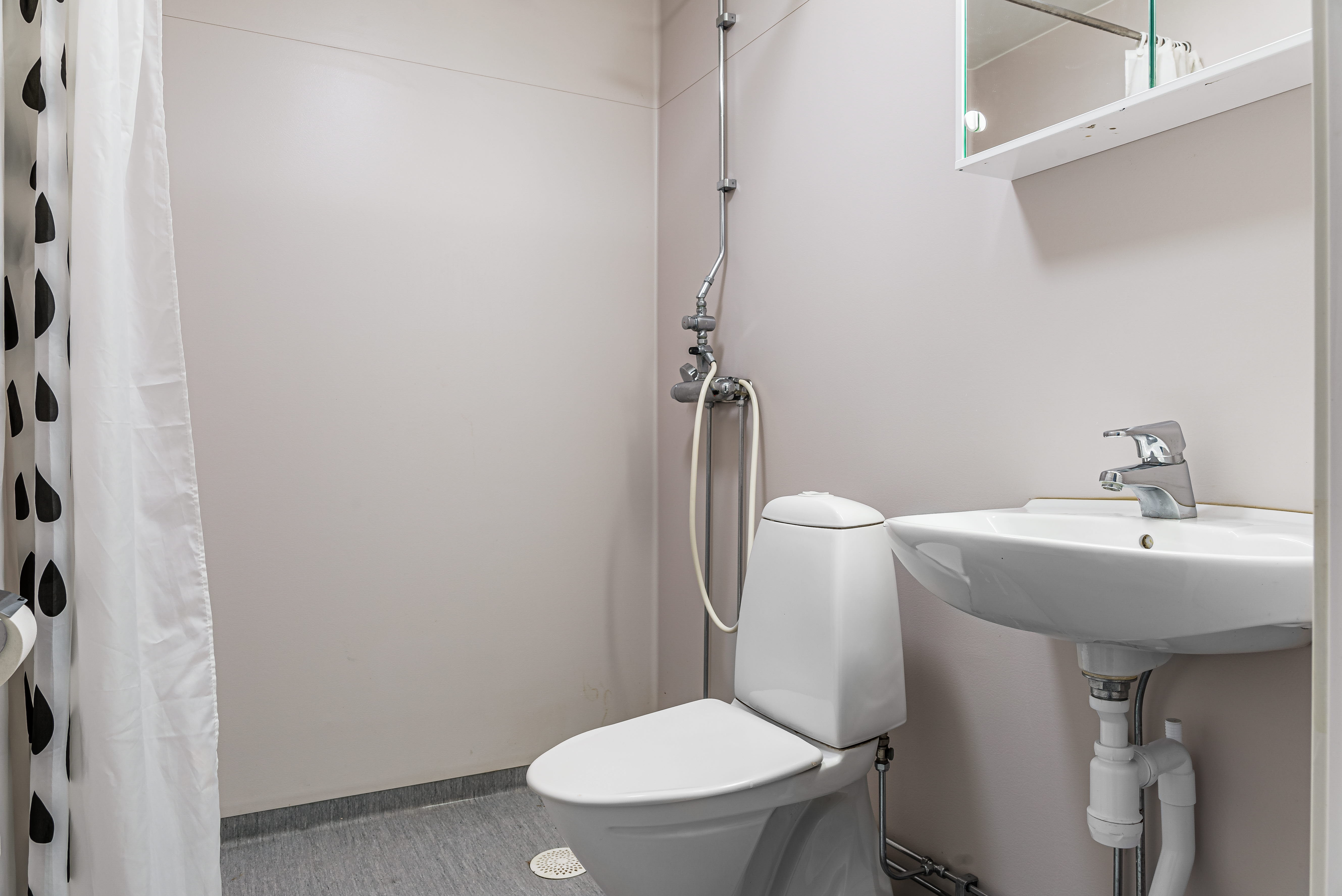 A shower that has a sink and a mirror