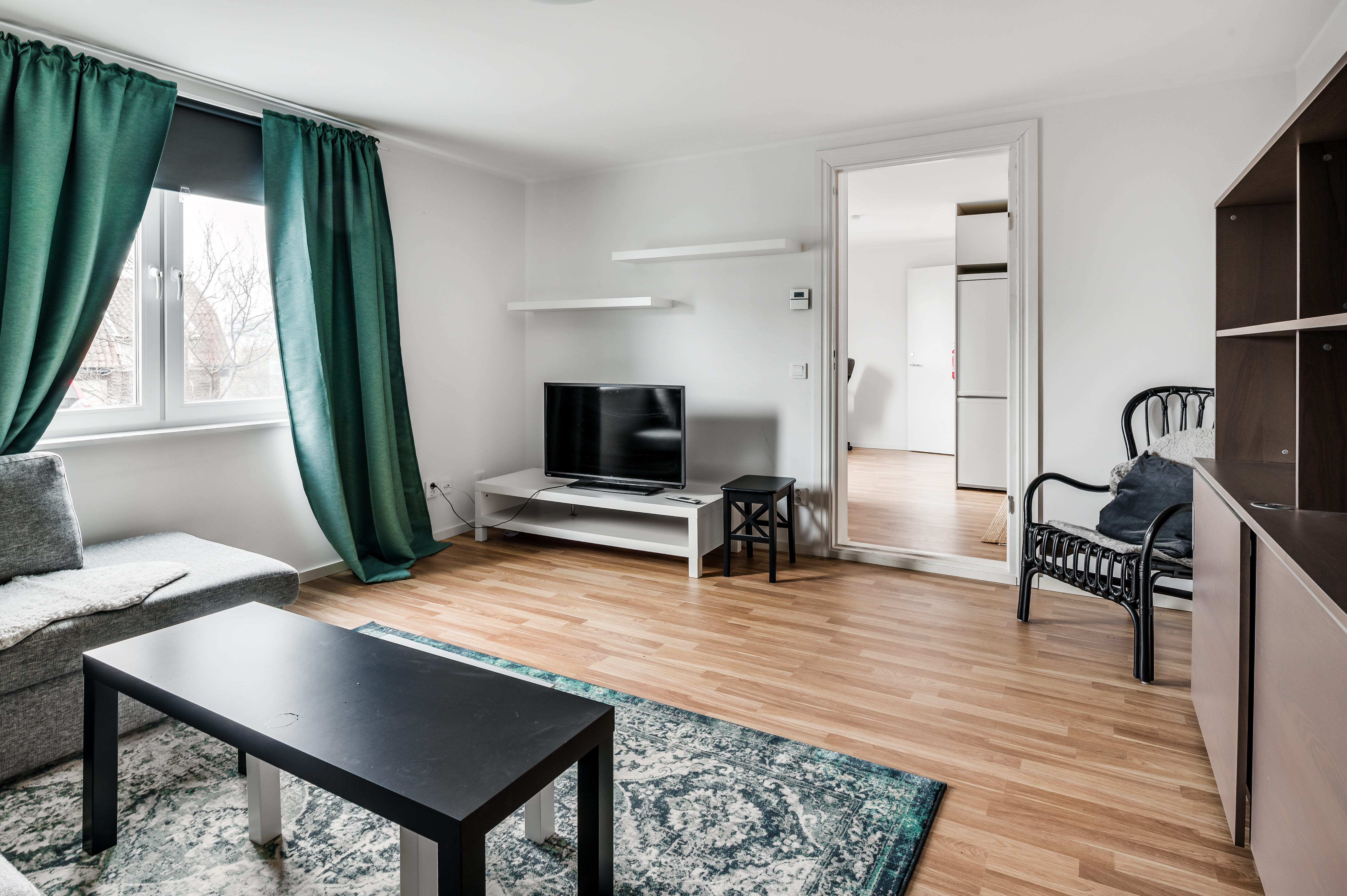 A living room filled with furniture and a large window