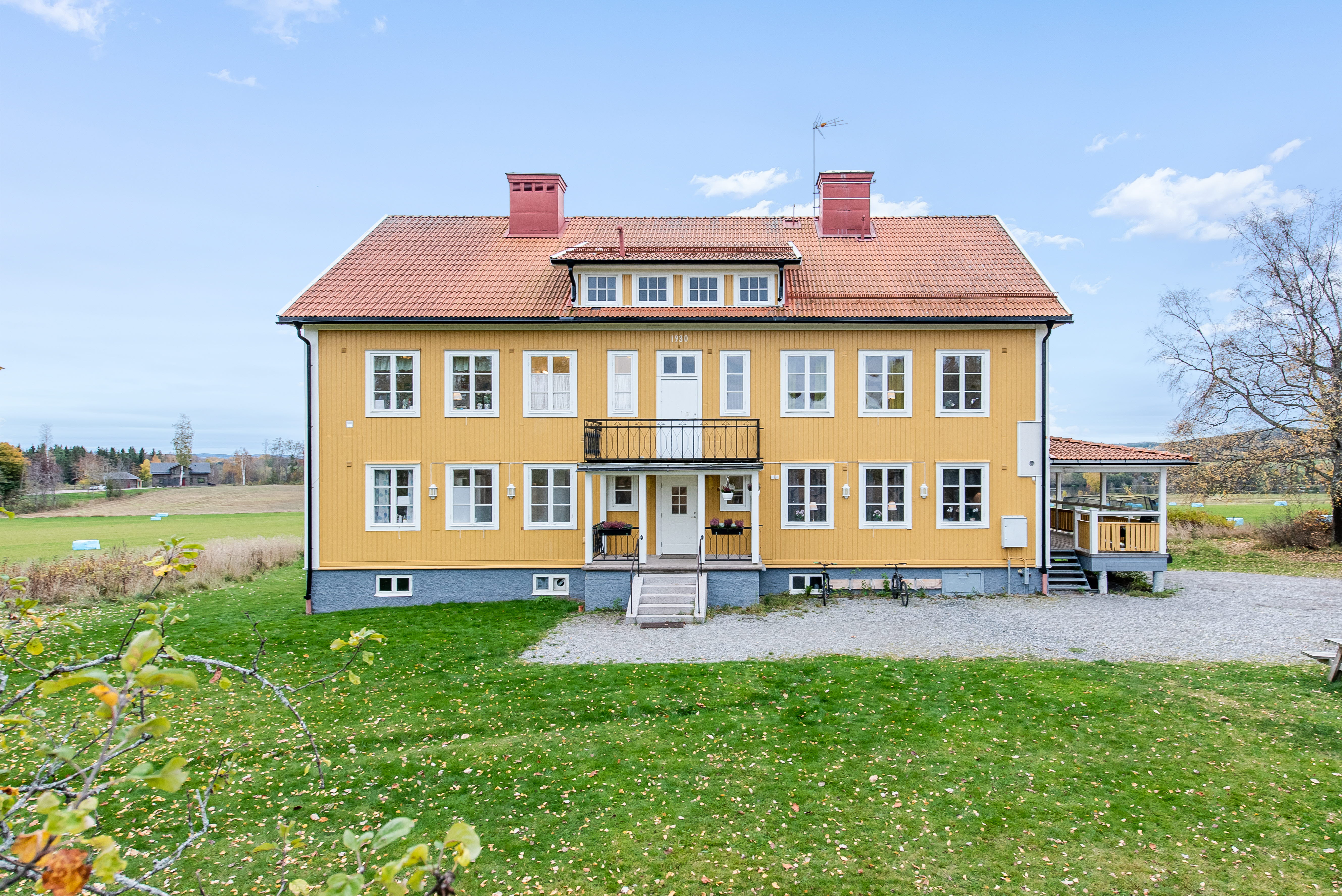 A small house in a field with Russian Bishop's House in the background