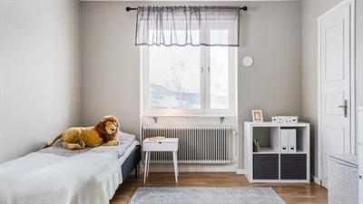 A bedroom with a large bed in a room