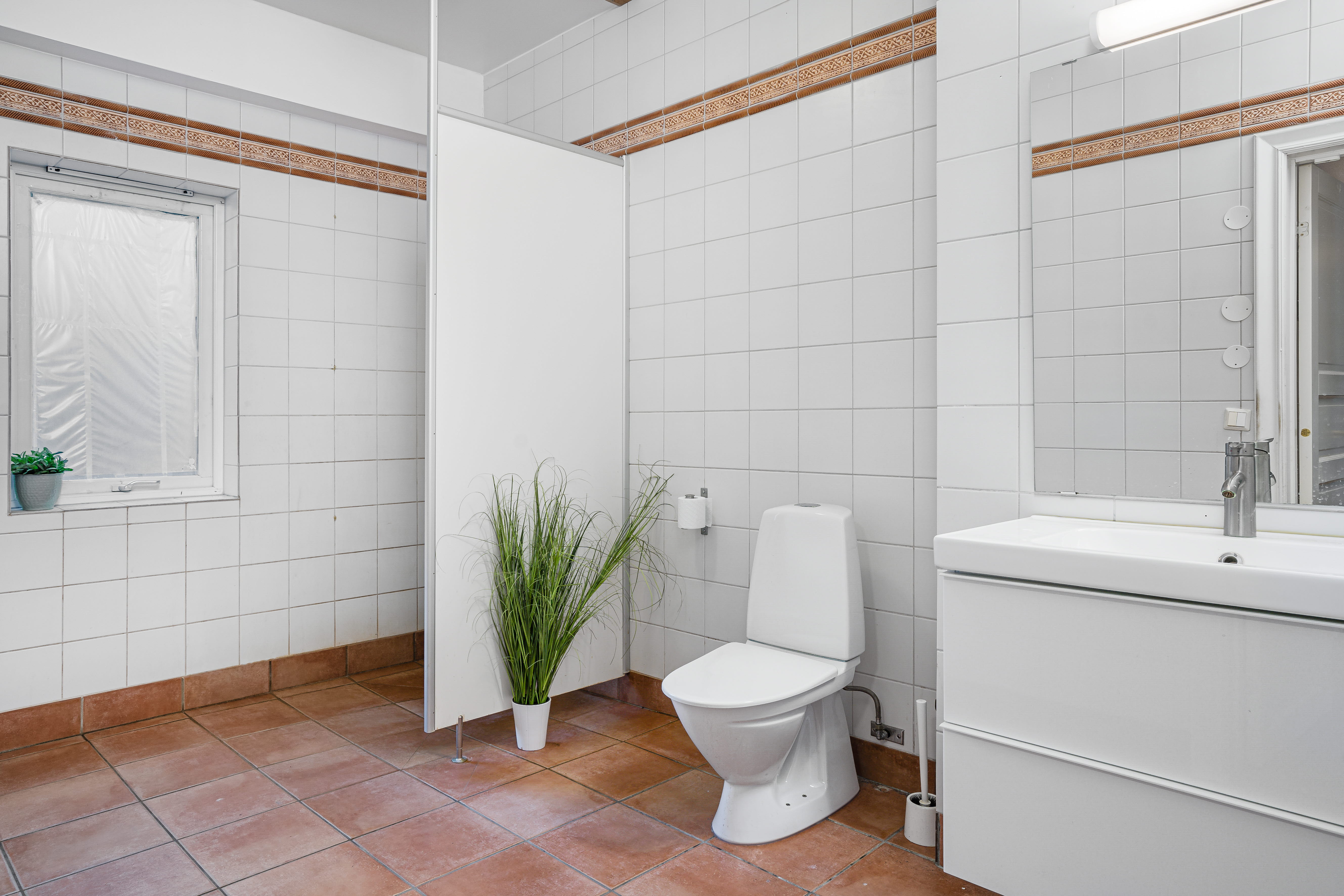 A room with a sink and a shower