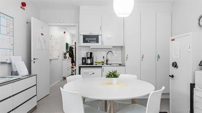 A kitchen with a table in a room