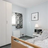 A bedroom with a bed in a room