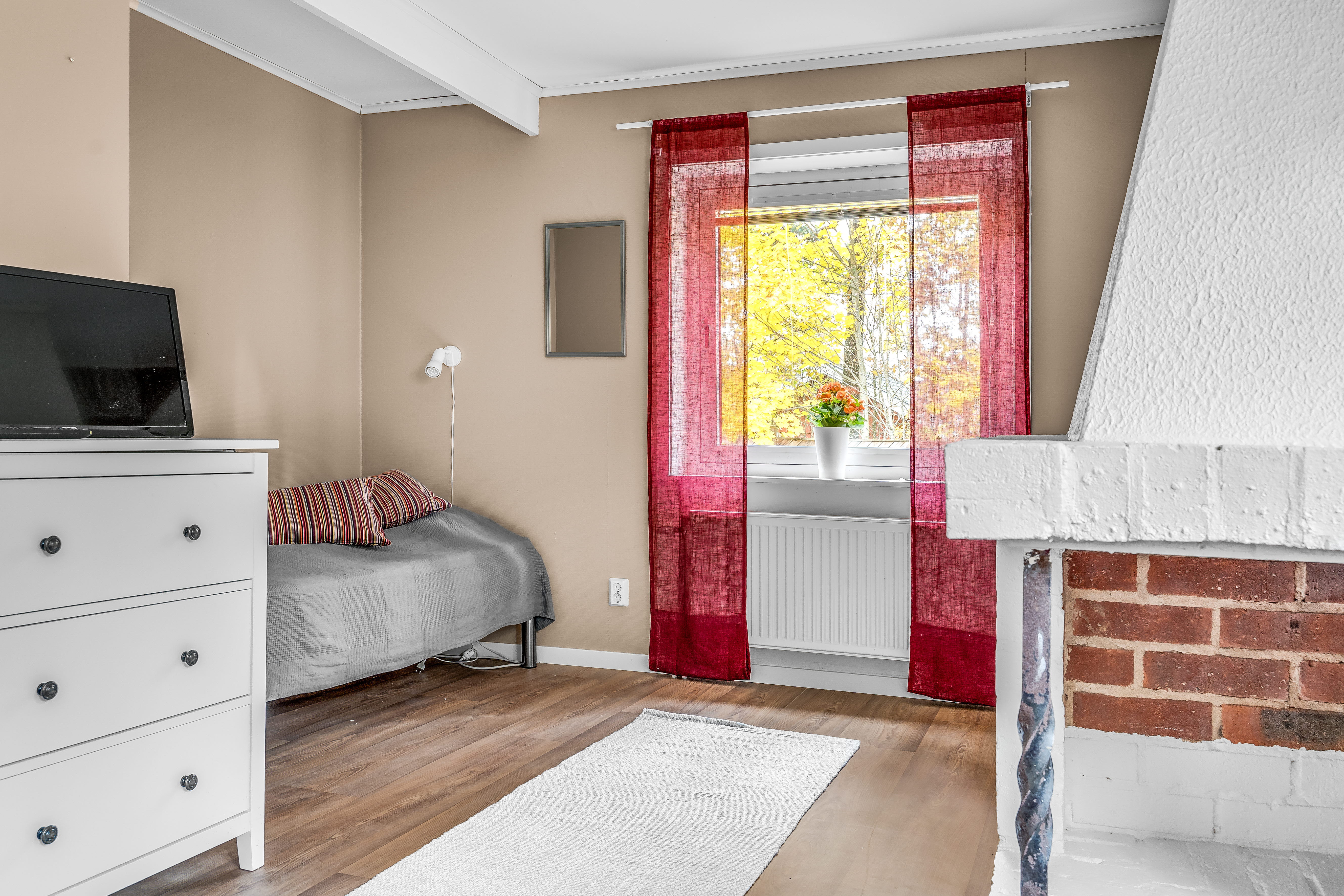 A bedroom with a bed in a room