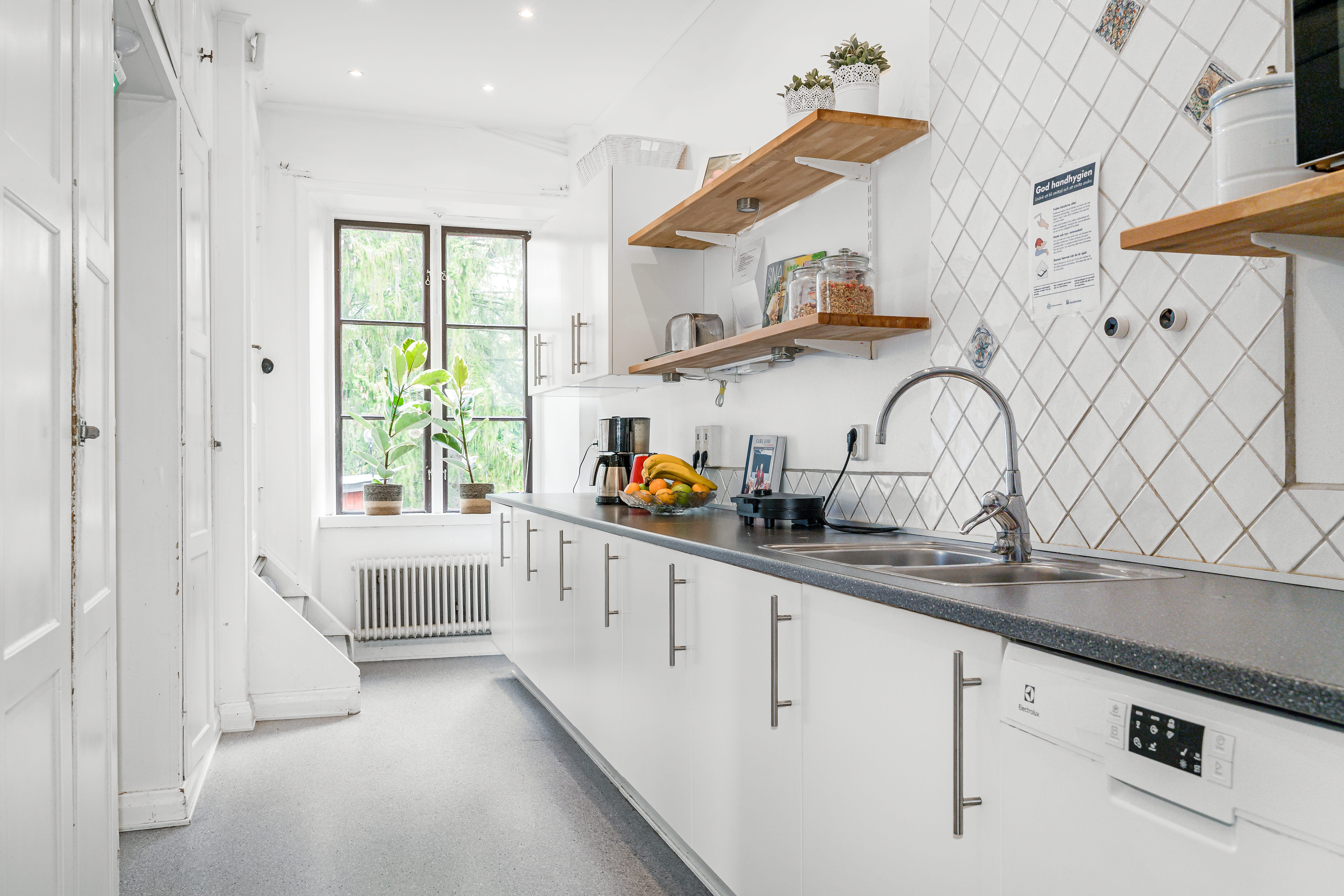 A kitchen with a sink and a window