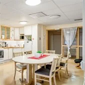 A kitchen with a dining room table