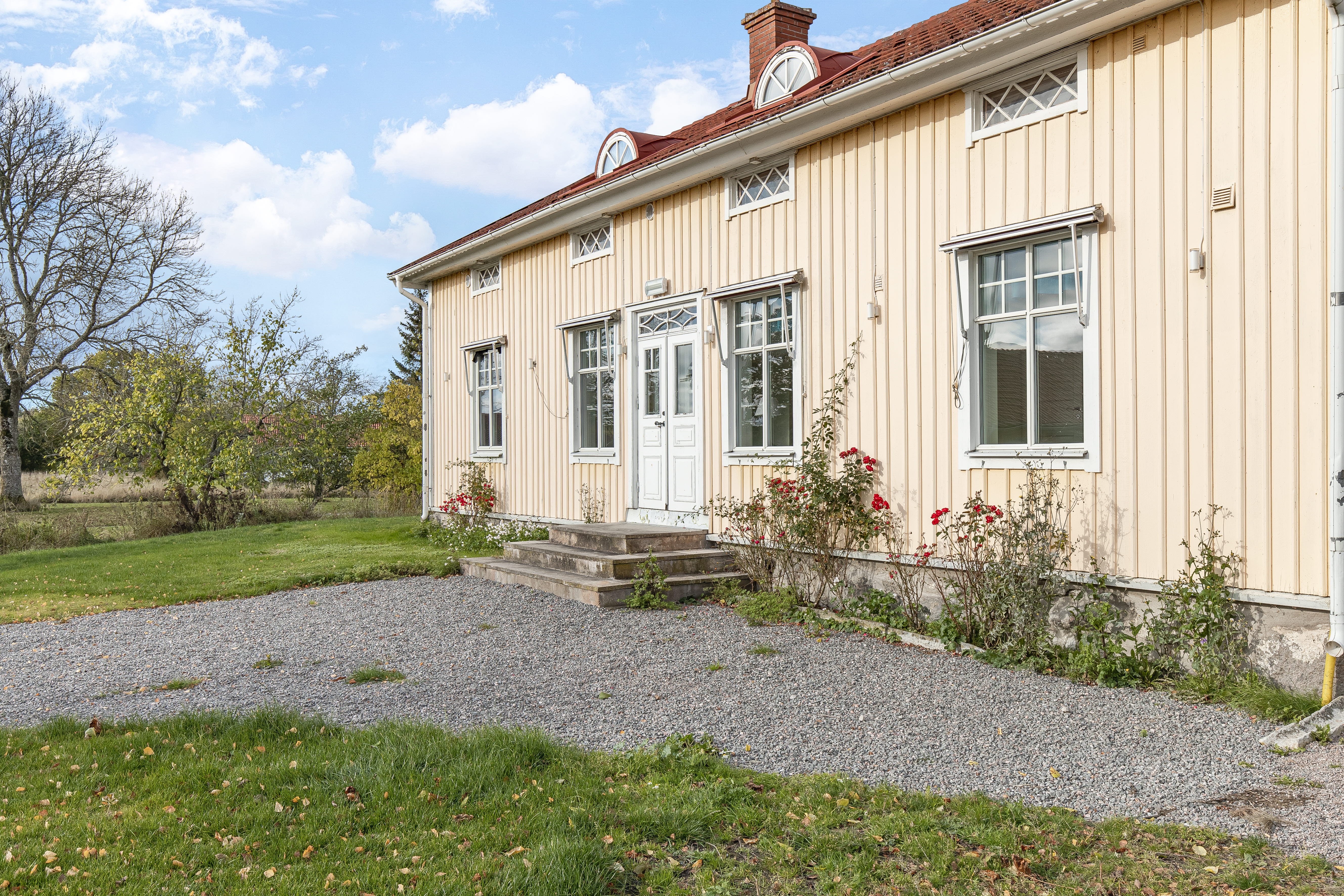 A large brick building with grass in front of a house