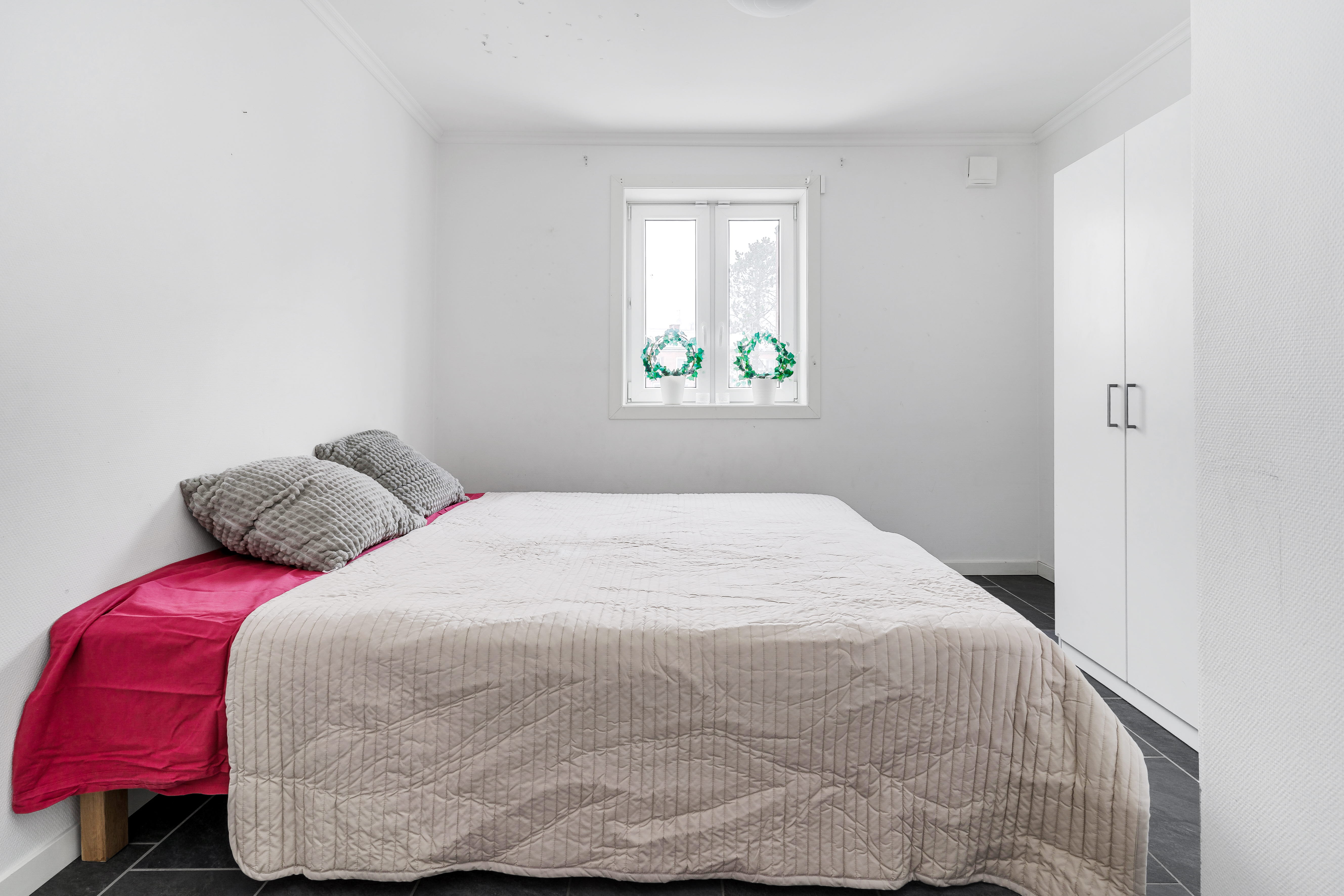A bedroom with a bed in a room
