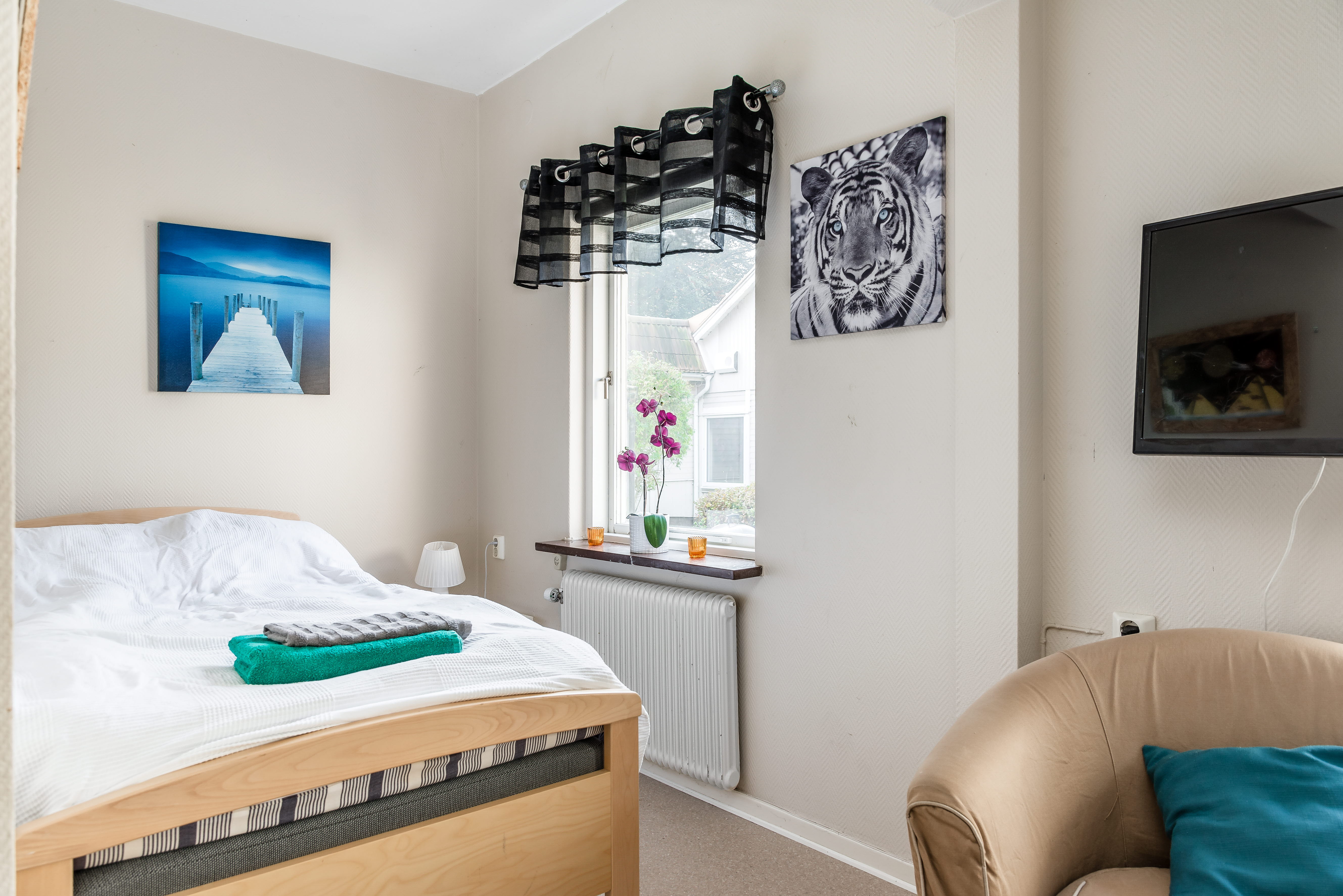 A bedroom with a bed in a room