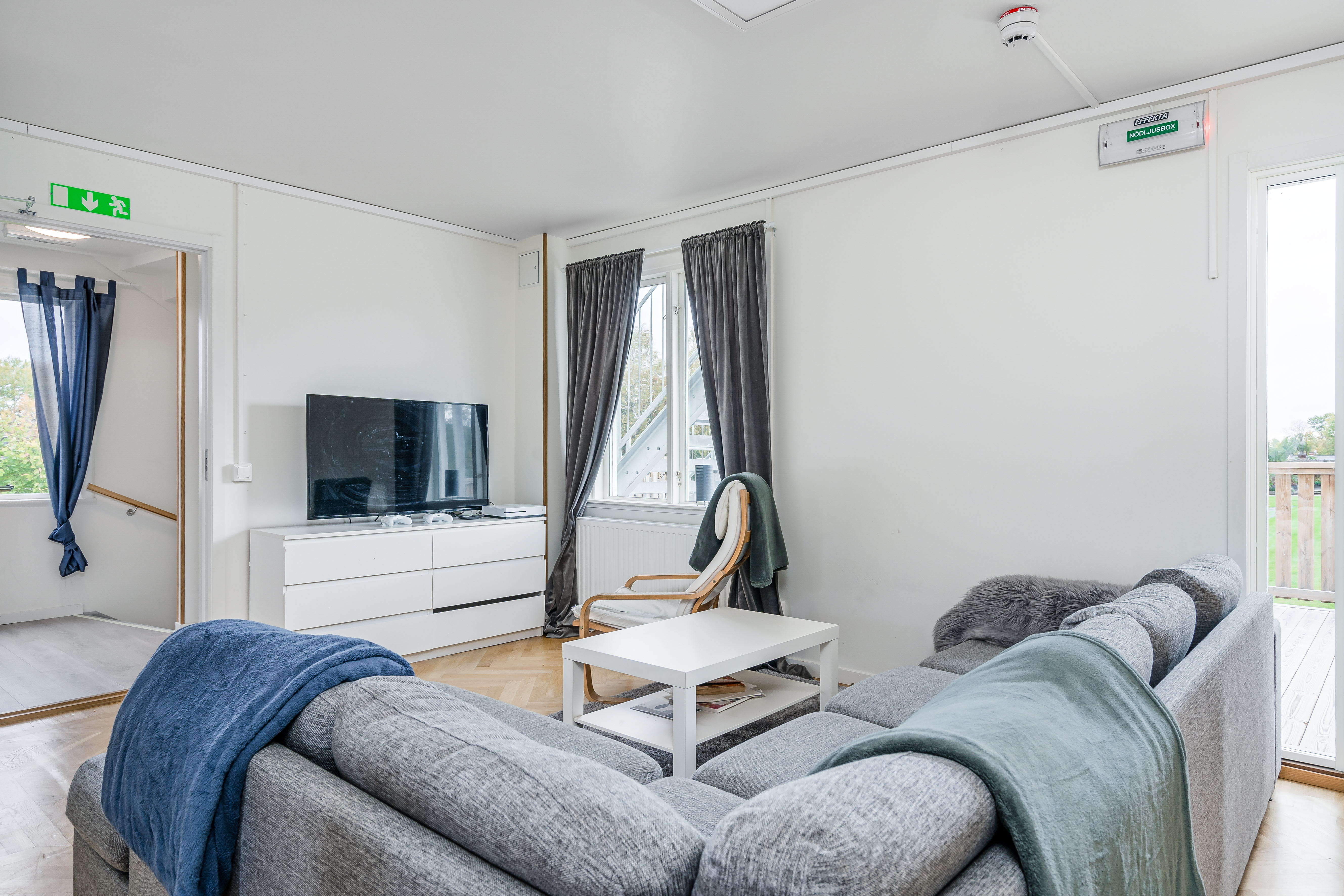 A living room filled with furniture and a large window