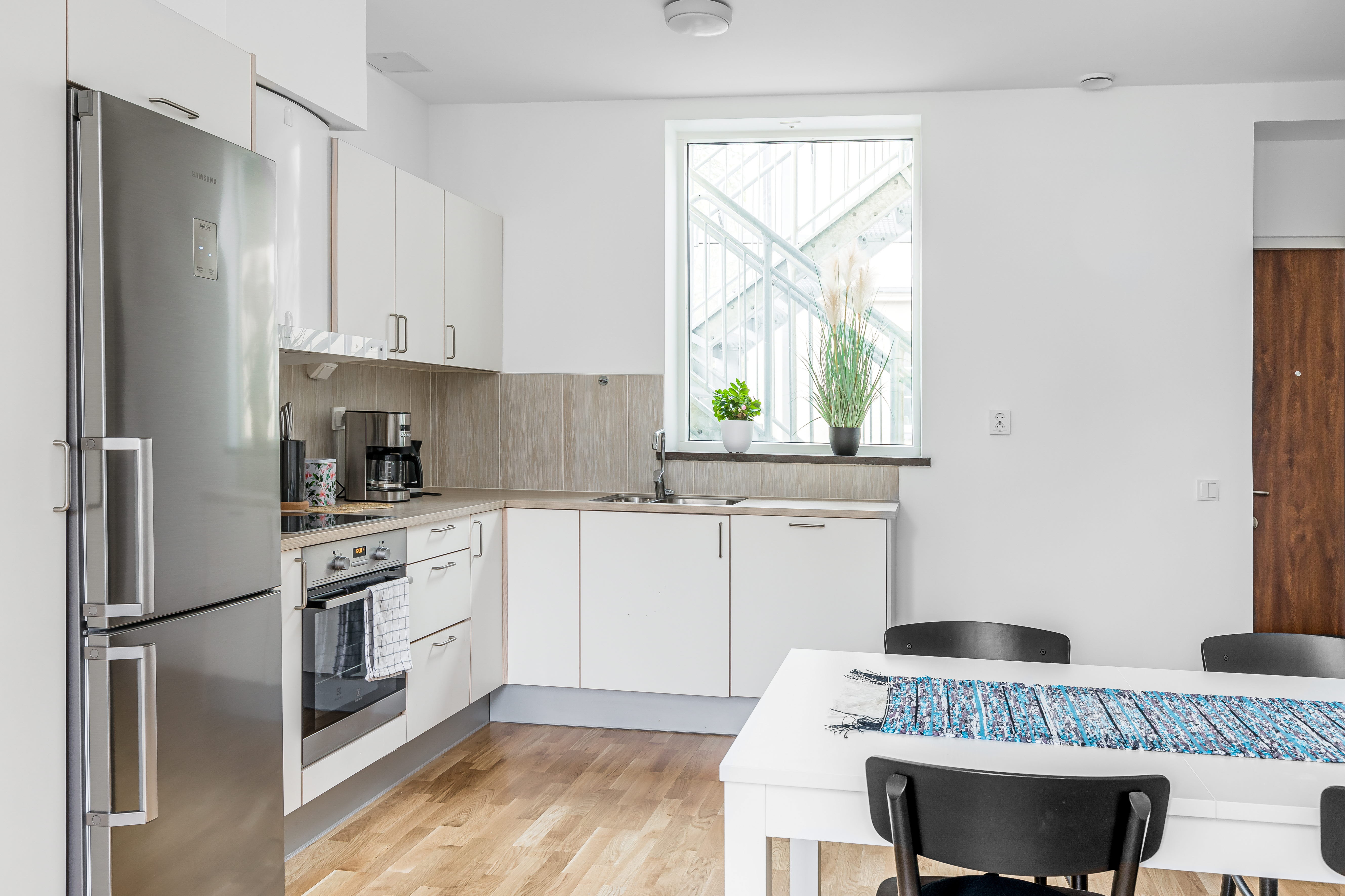 A kitchen with a sink and a window