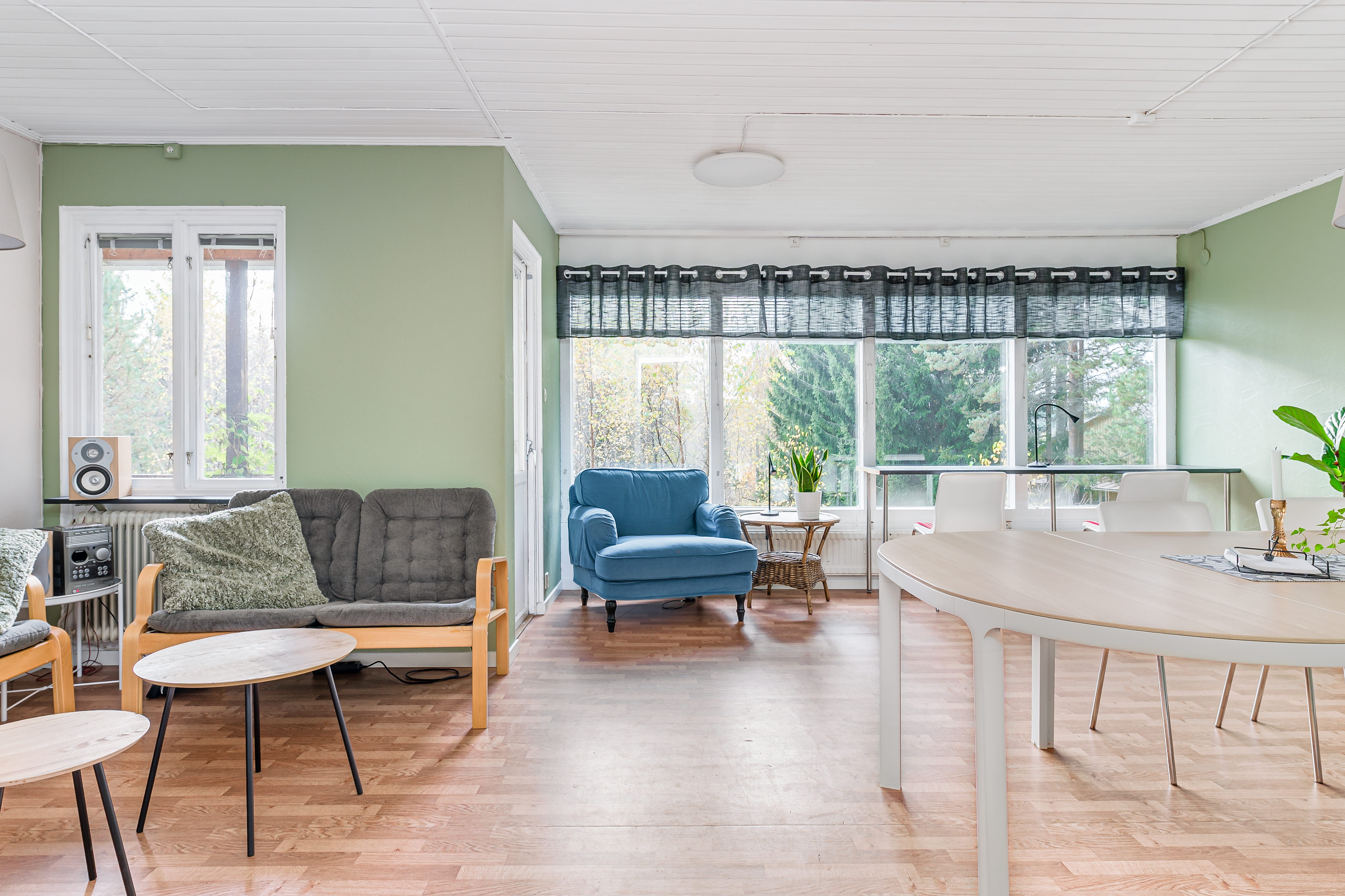 A living room filled with furniture on top of a hard wood floor