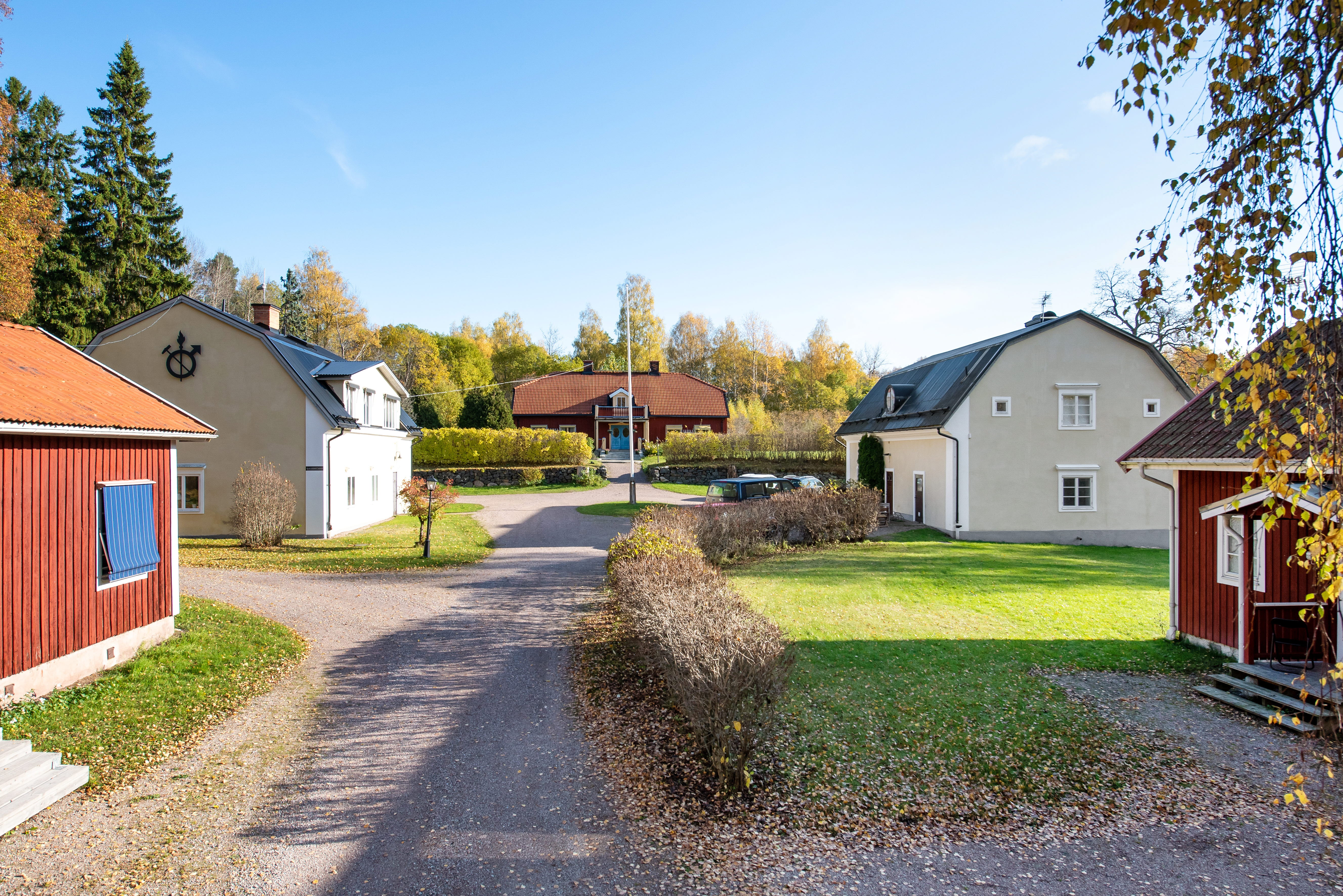 A dirt road in front of a house