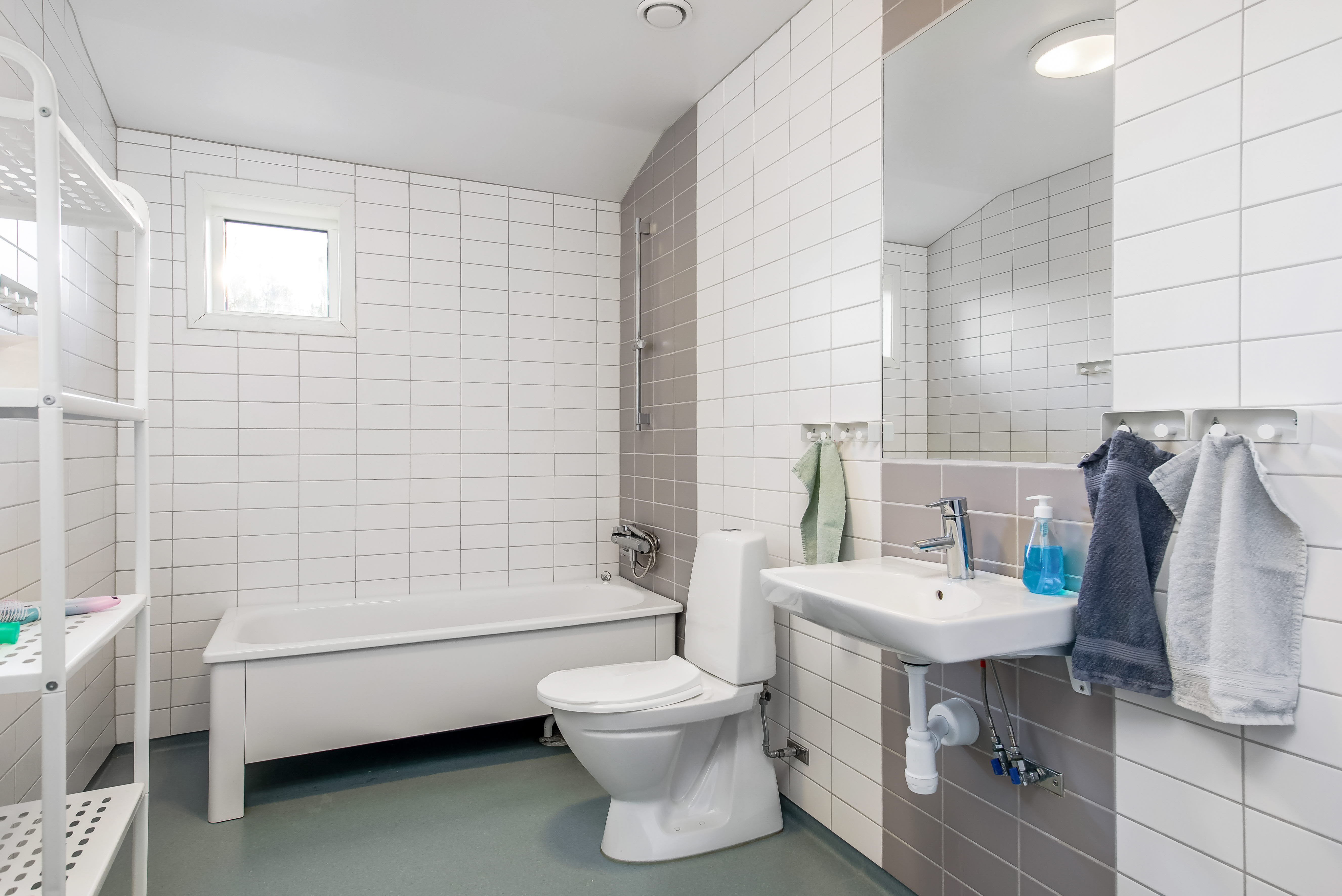 A room with a sink and a bath tub