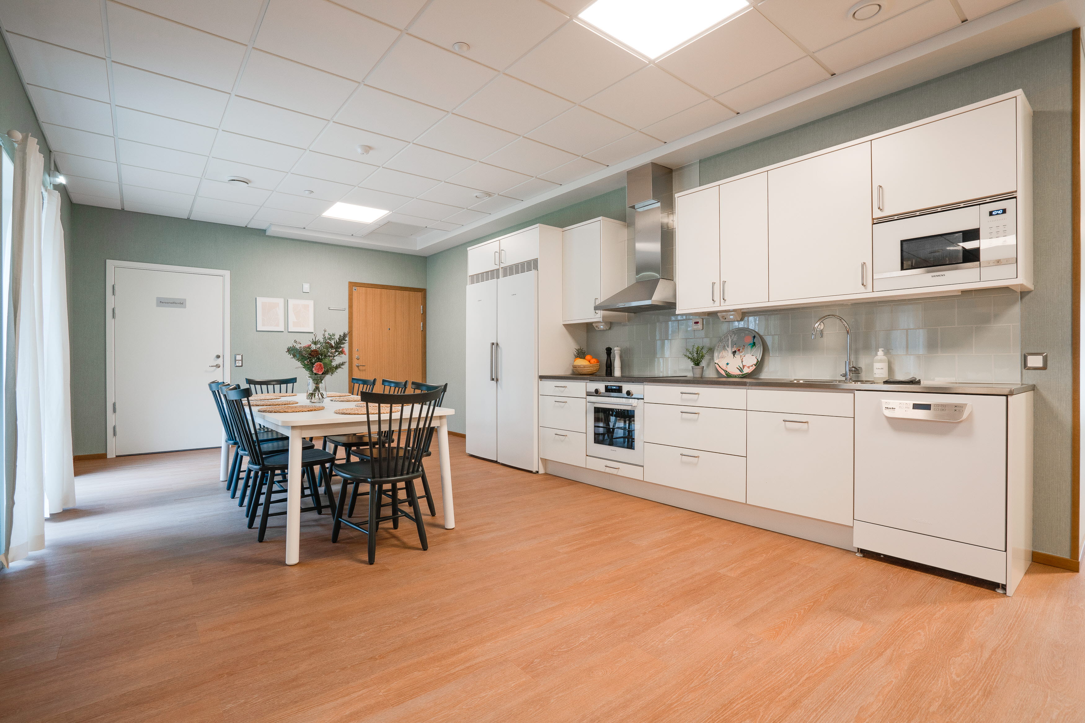 A kitchen with a wood floor