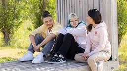 A group of people sitting on a bench