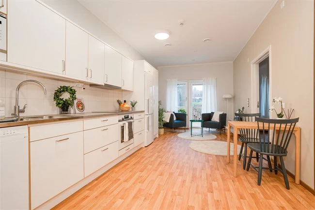 A kitchen with a wood floor