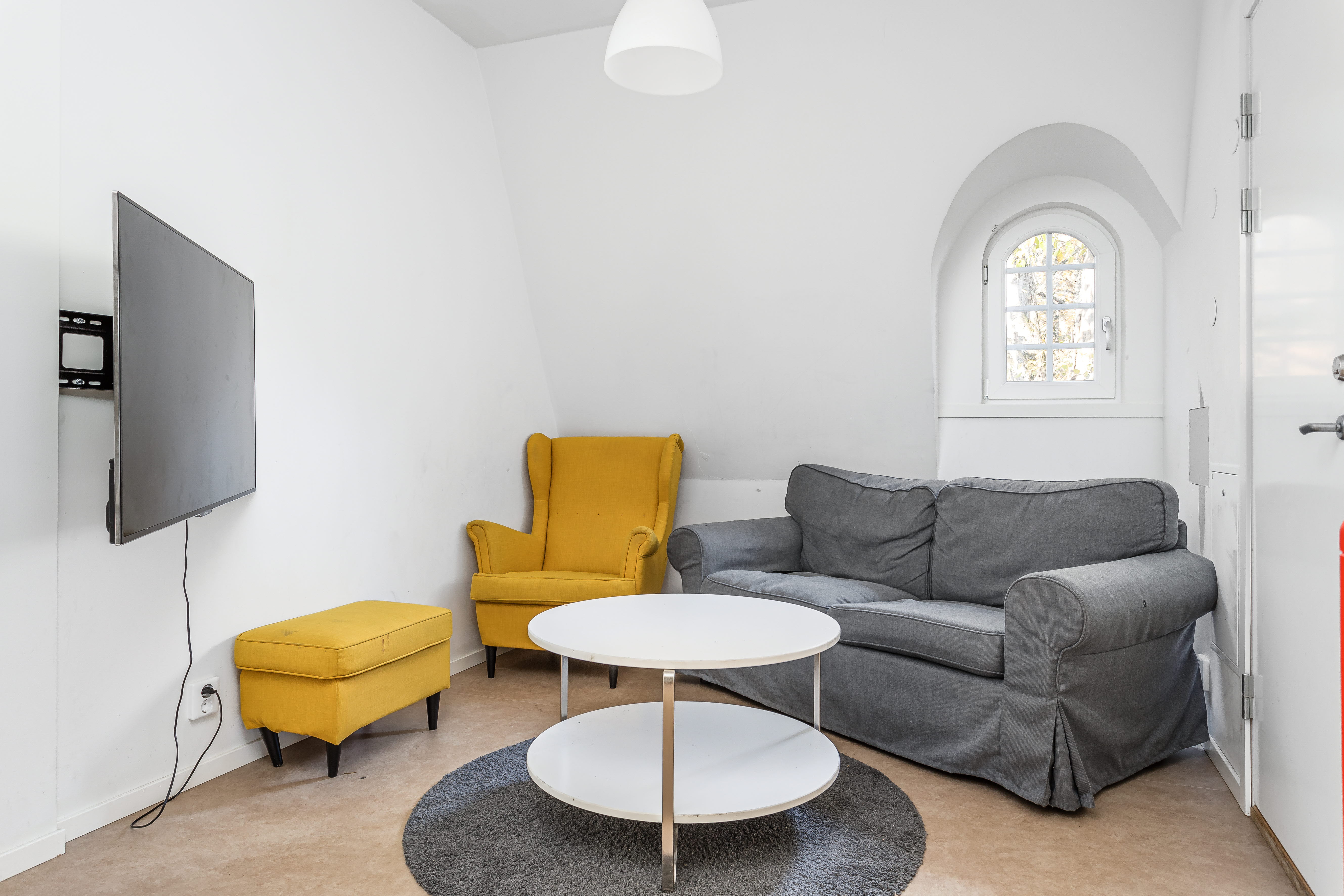A living room filled with furniture and a large window