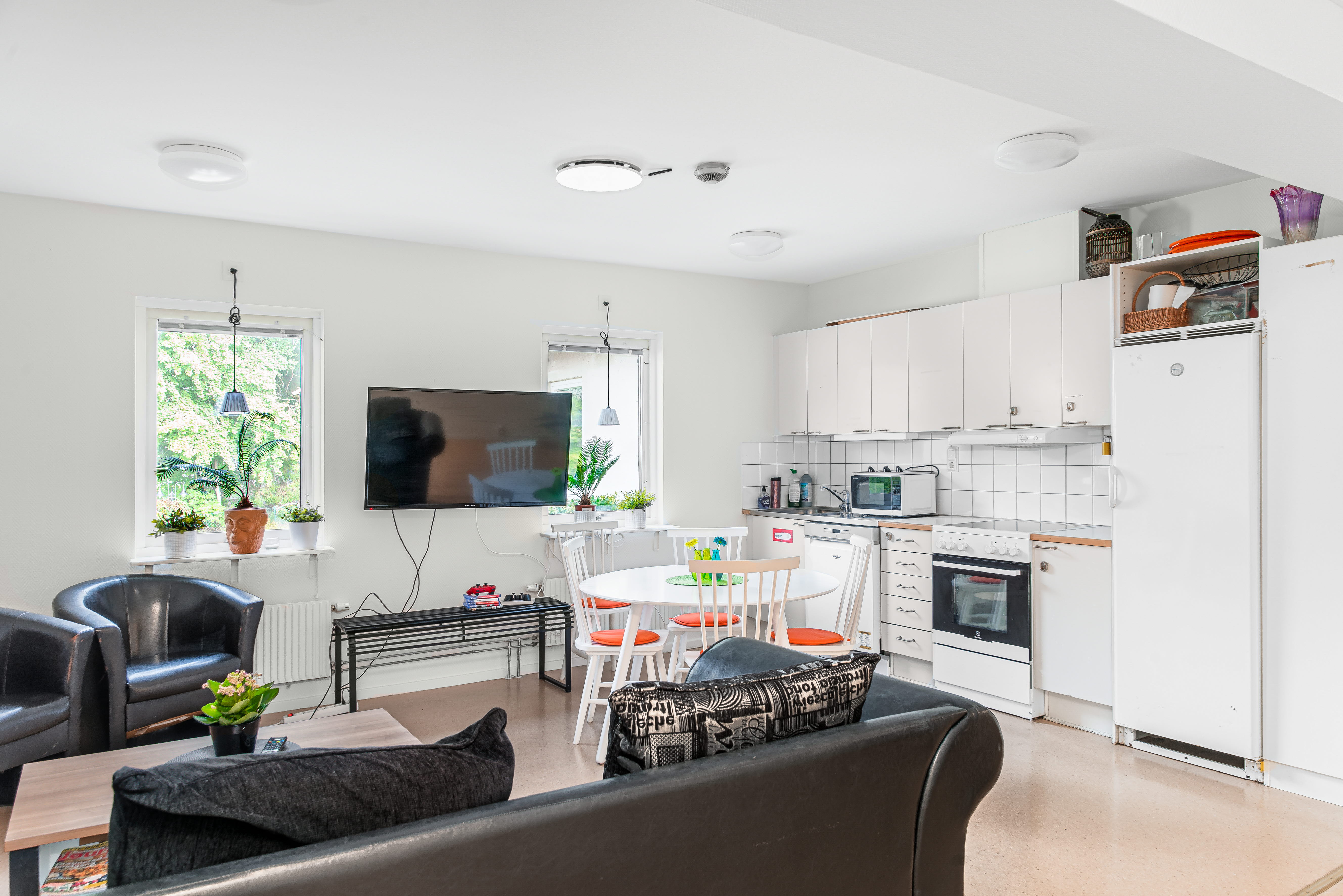 A living room filled with furniture and a counter in a kitchen