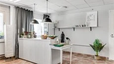 A kitchen with a table in a room
