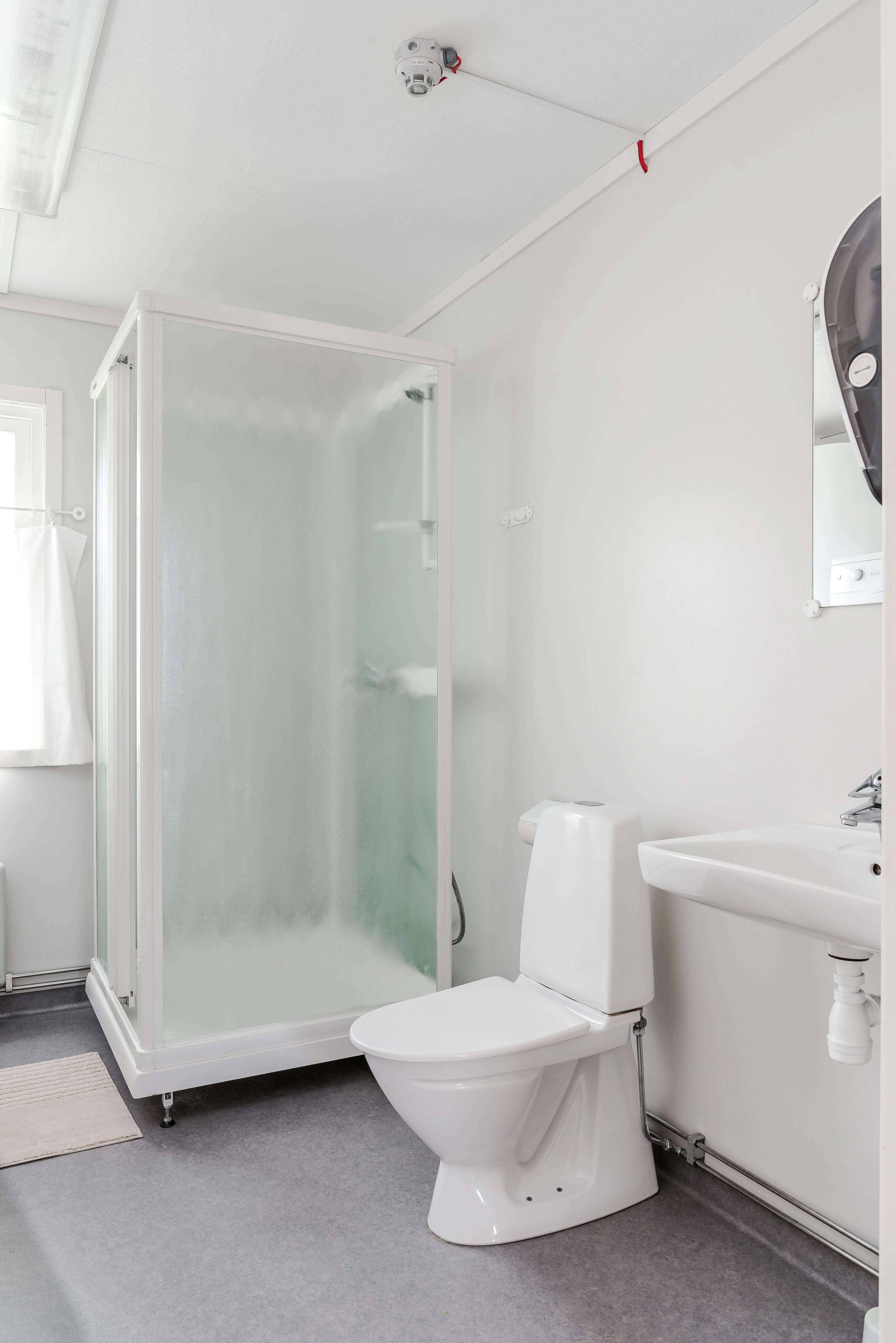 A room with a sink and a shower