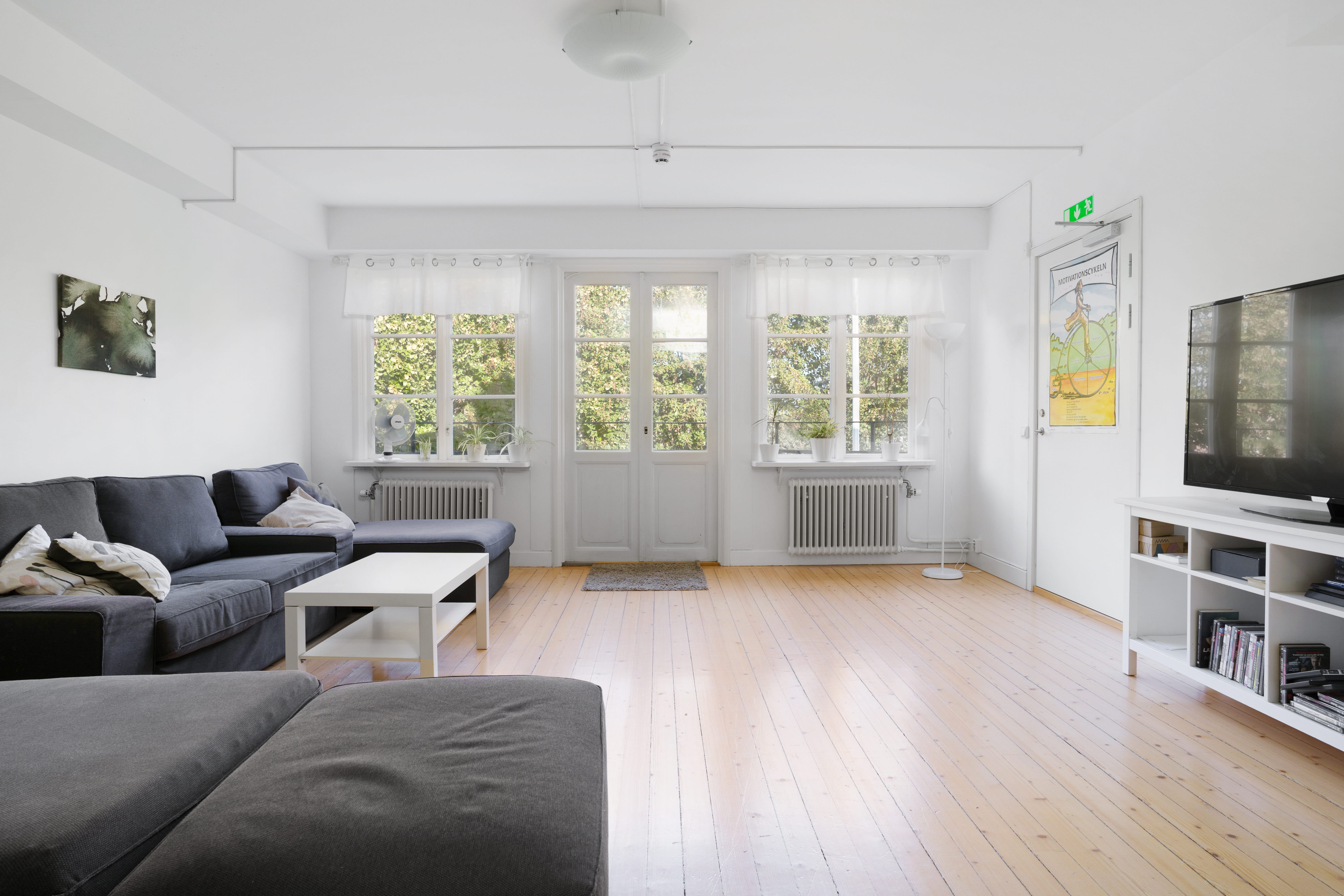 A living room filled with furniture and a large window