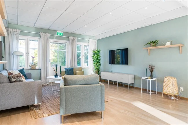 A living room filled with furniture and a large window