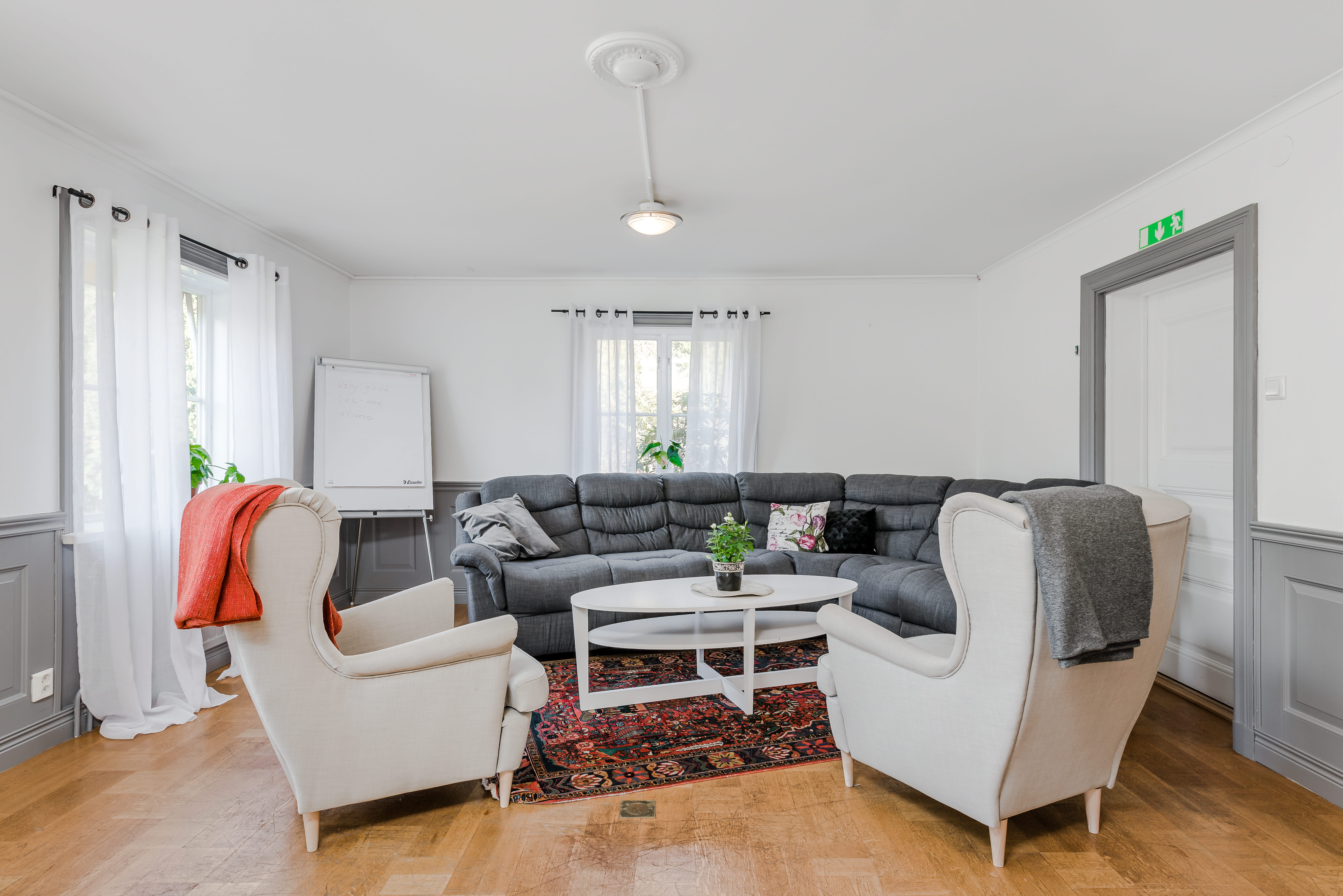A living room filled with furniture on top of a hard wood floor