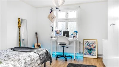 A bedroom with a bed in a room