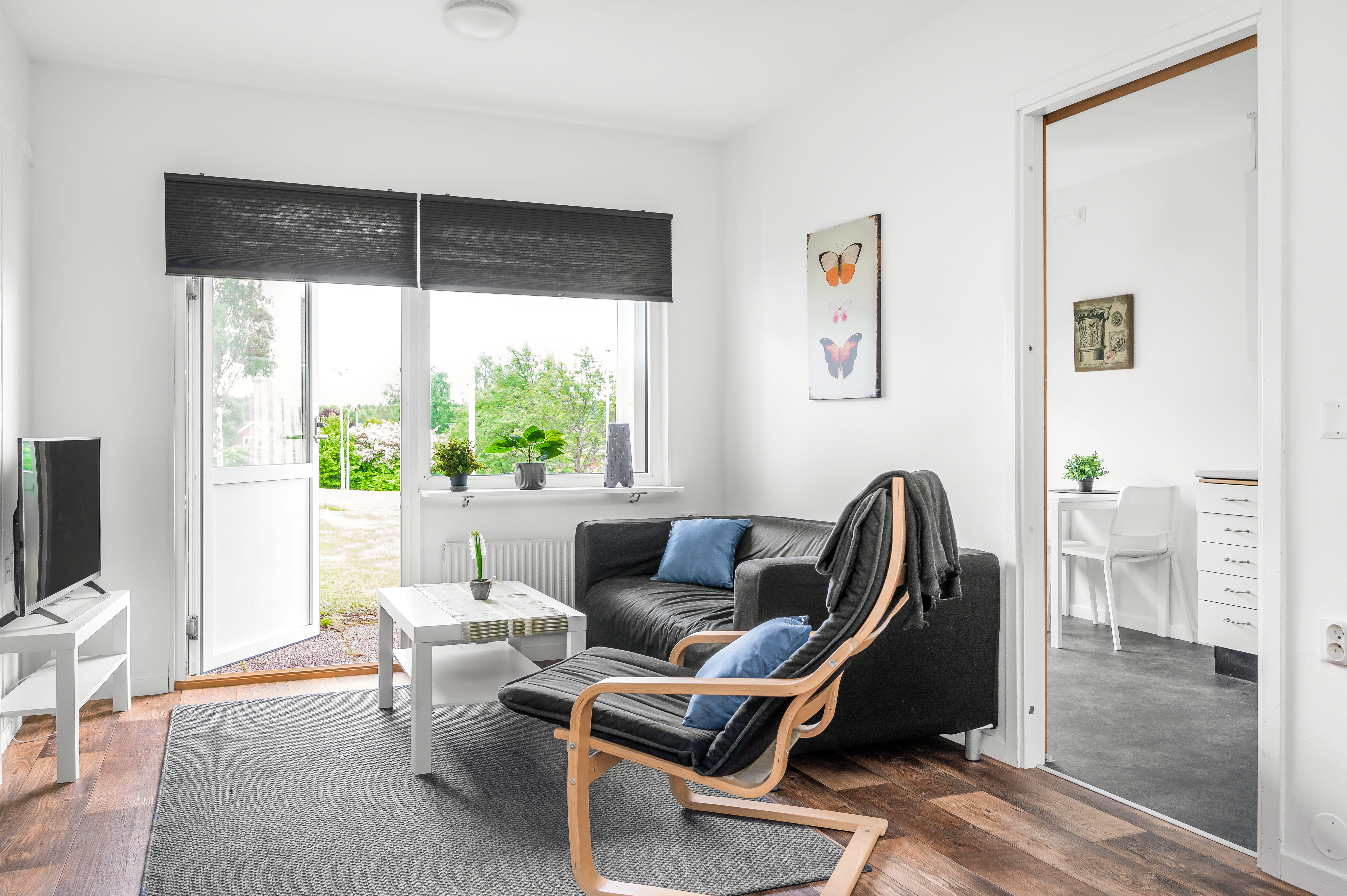A living room filled with furniture and a large window