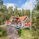 Vy över ett rött hus på Alma Gård