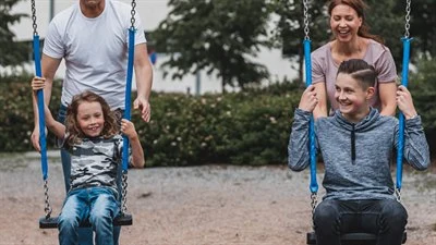 Children swinging with adults.