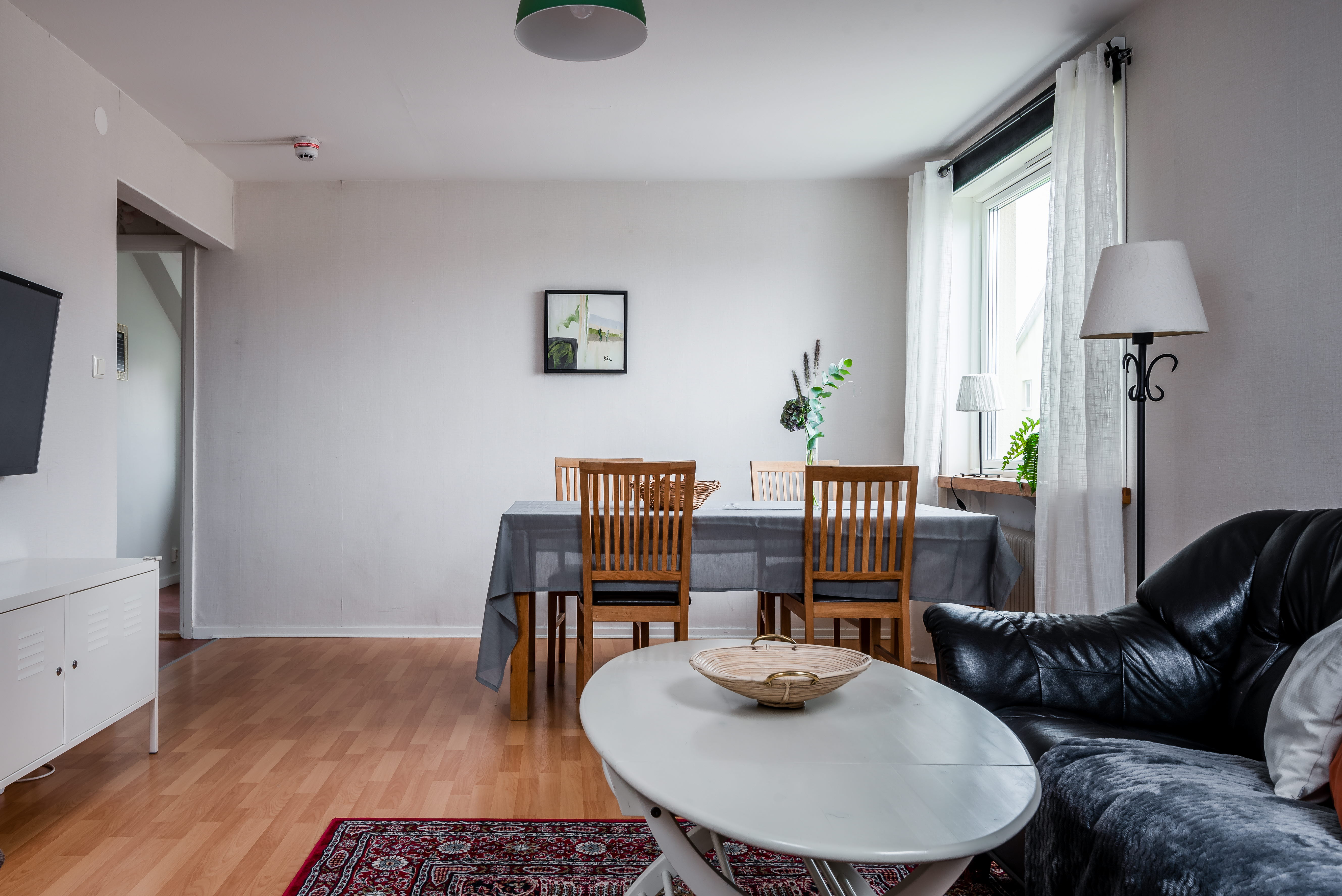 A living room filled with furniture and a wood floor