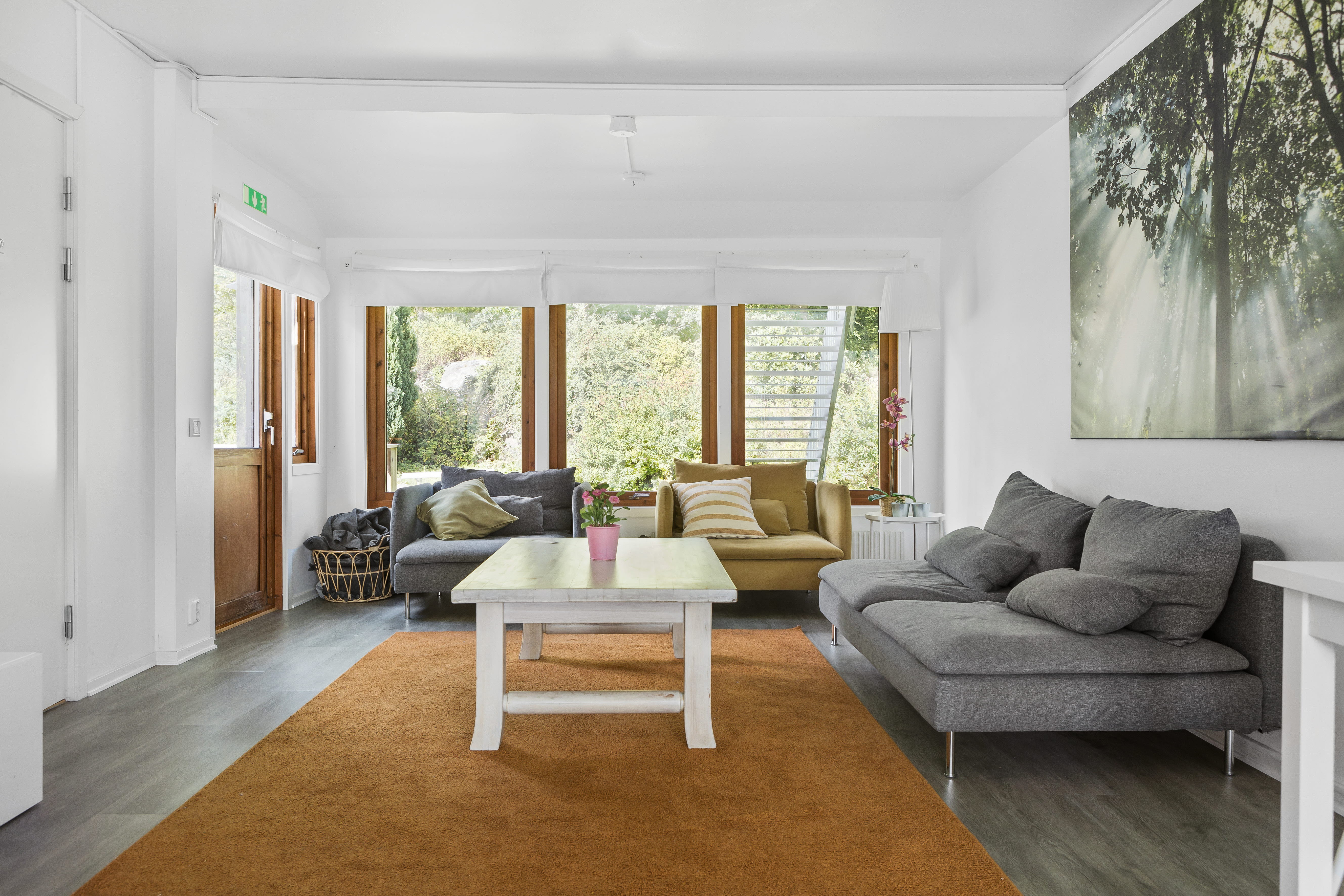A living room filled with furniture and a large window