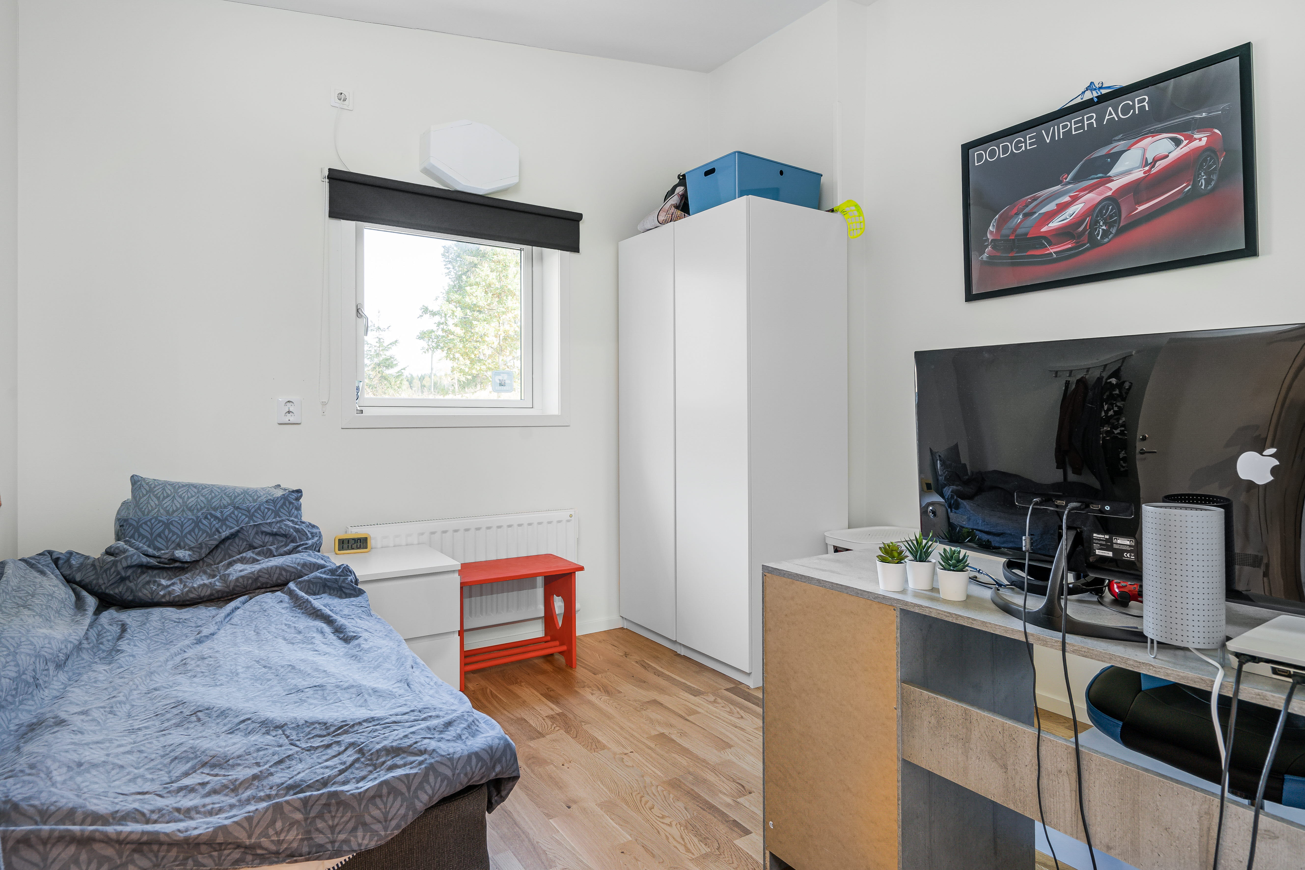 A bedroom with a bed in a room
