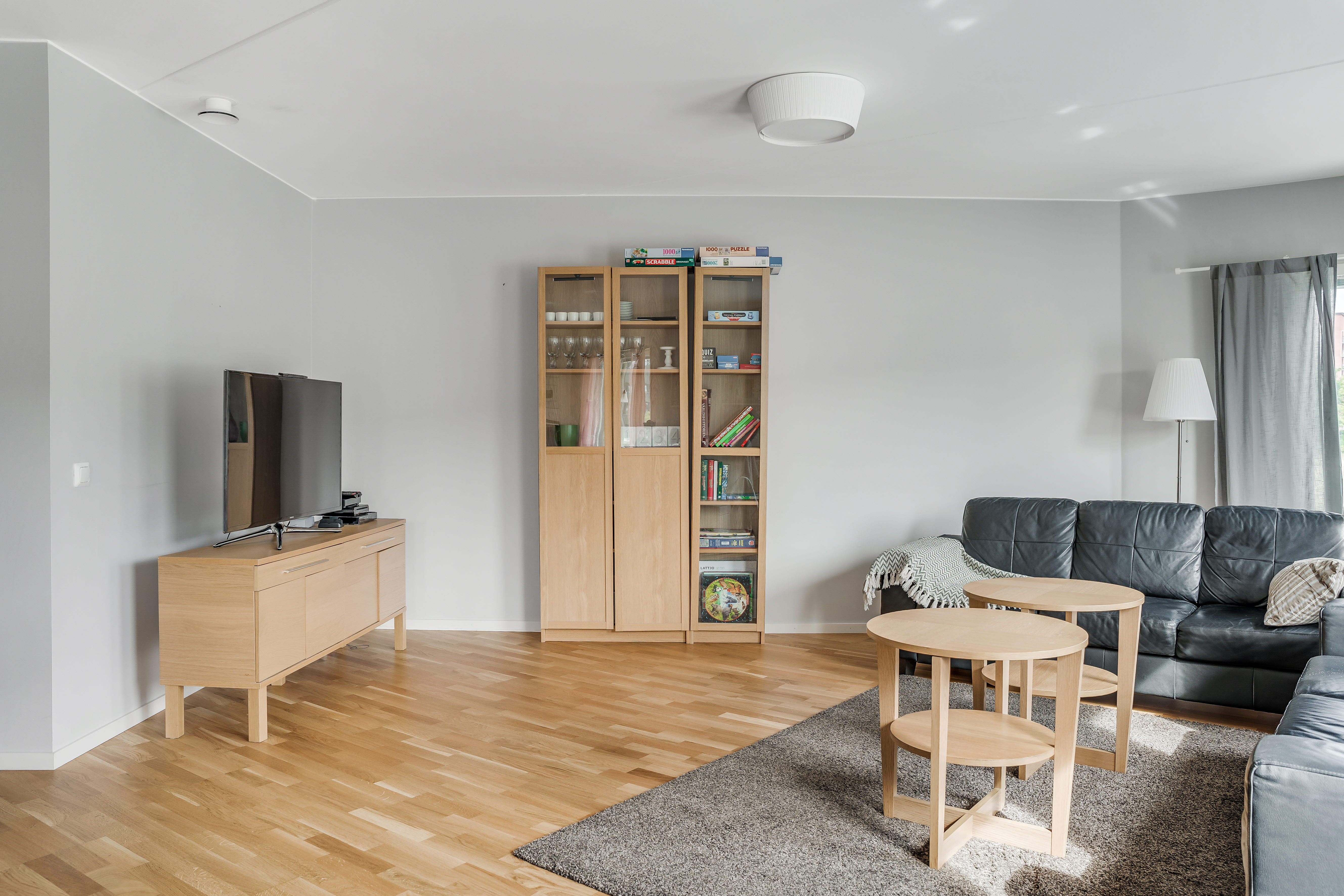 A living room filled with furniture on top of a hard wood floor