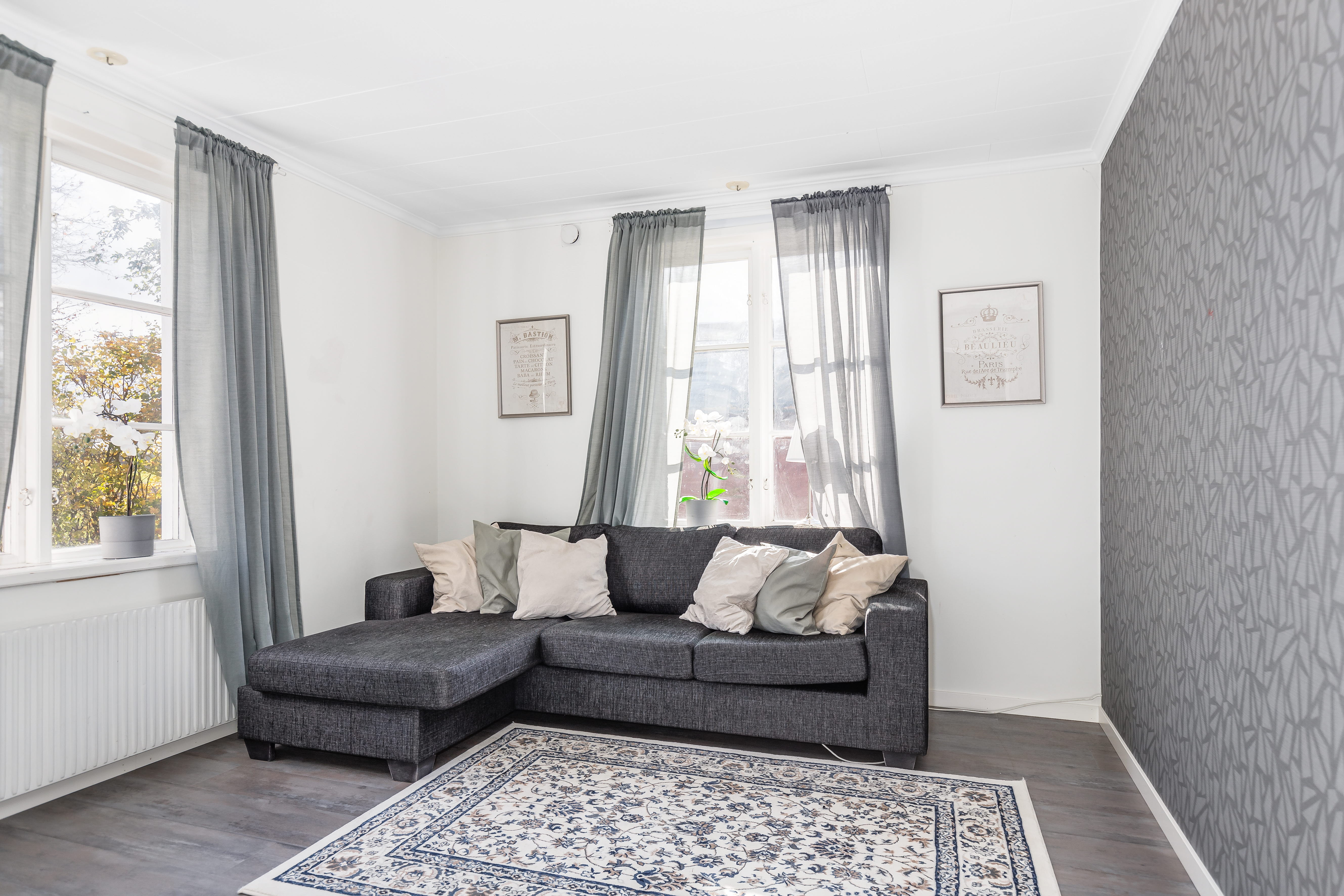 A living room filled with furniture and a large window