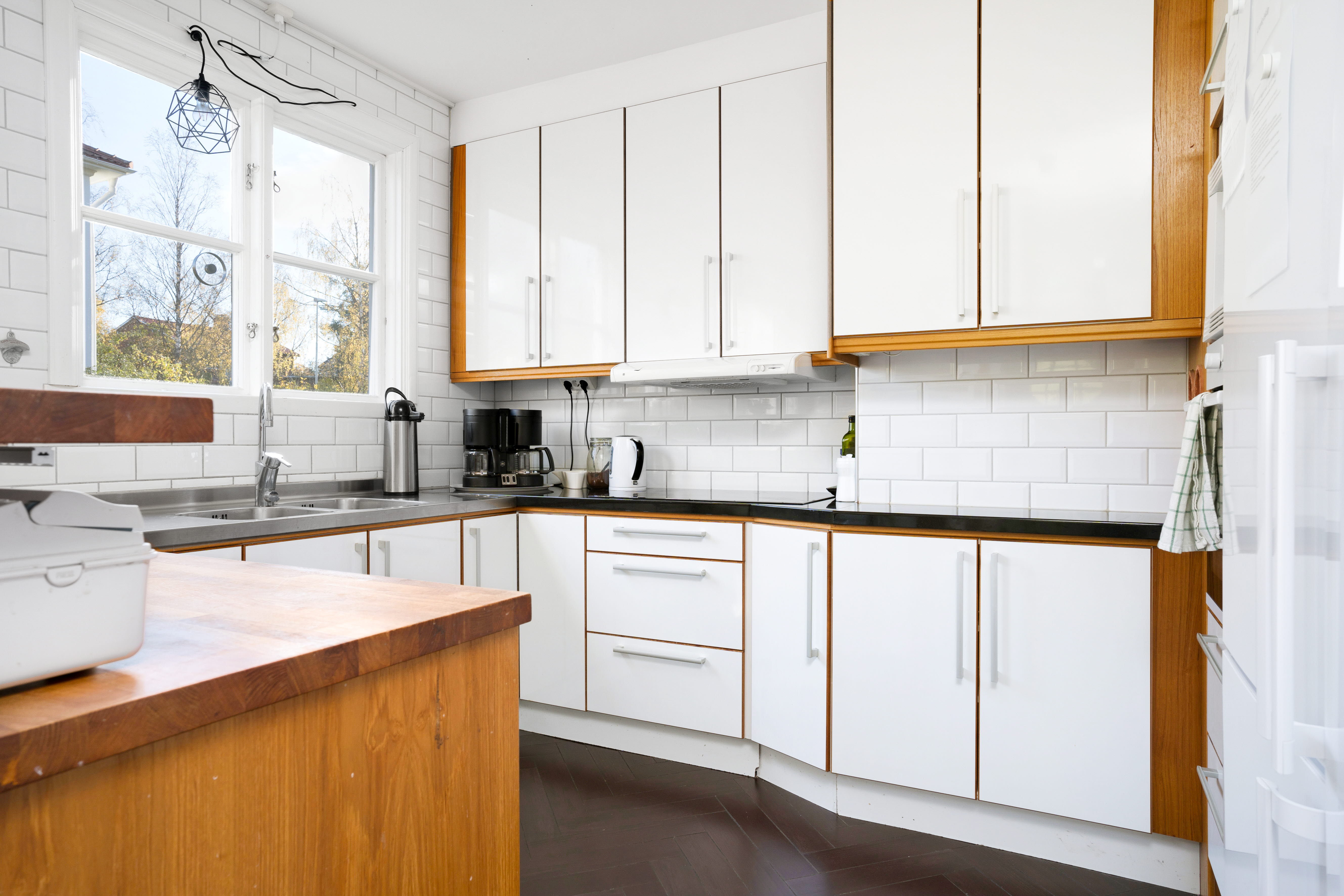 A kitchen with a sink and a window