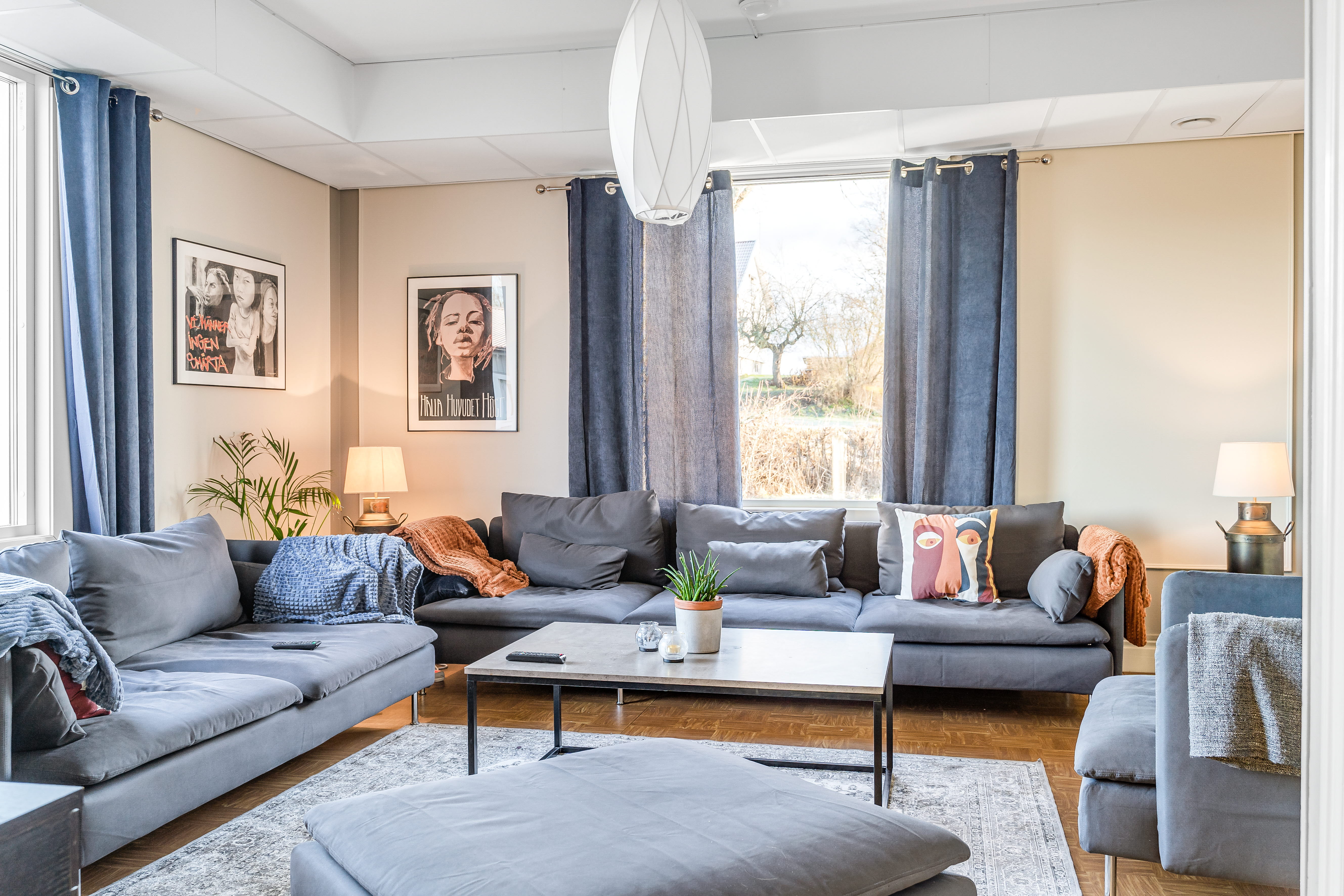 A living room filled with furniture and a large window