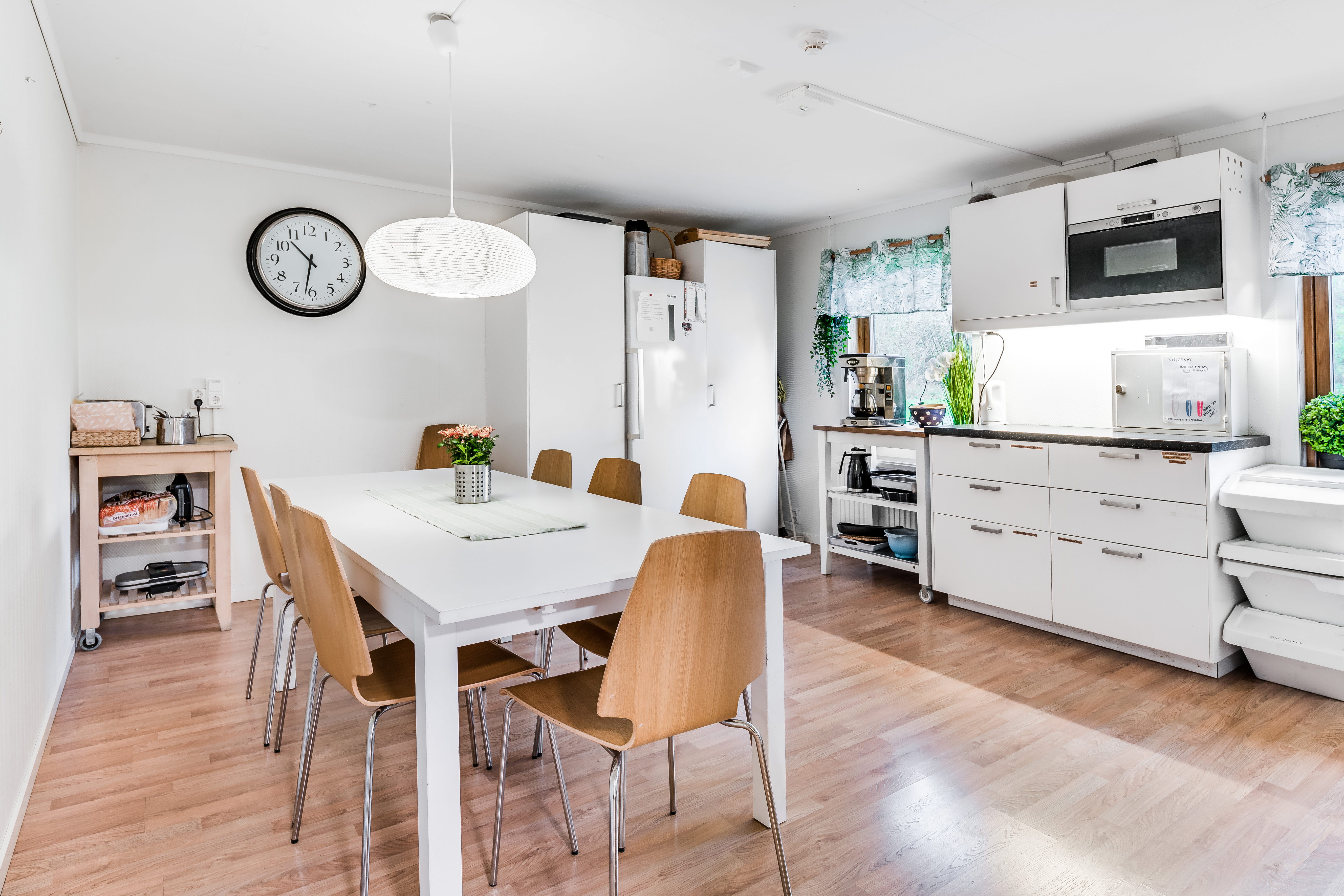A kitchen with a wood floor in a room