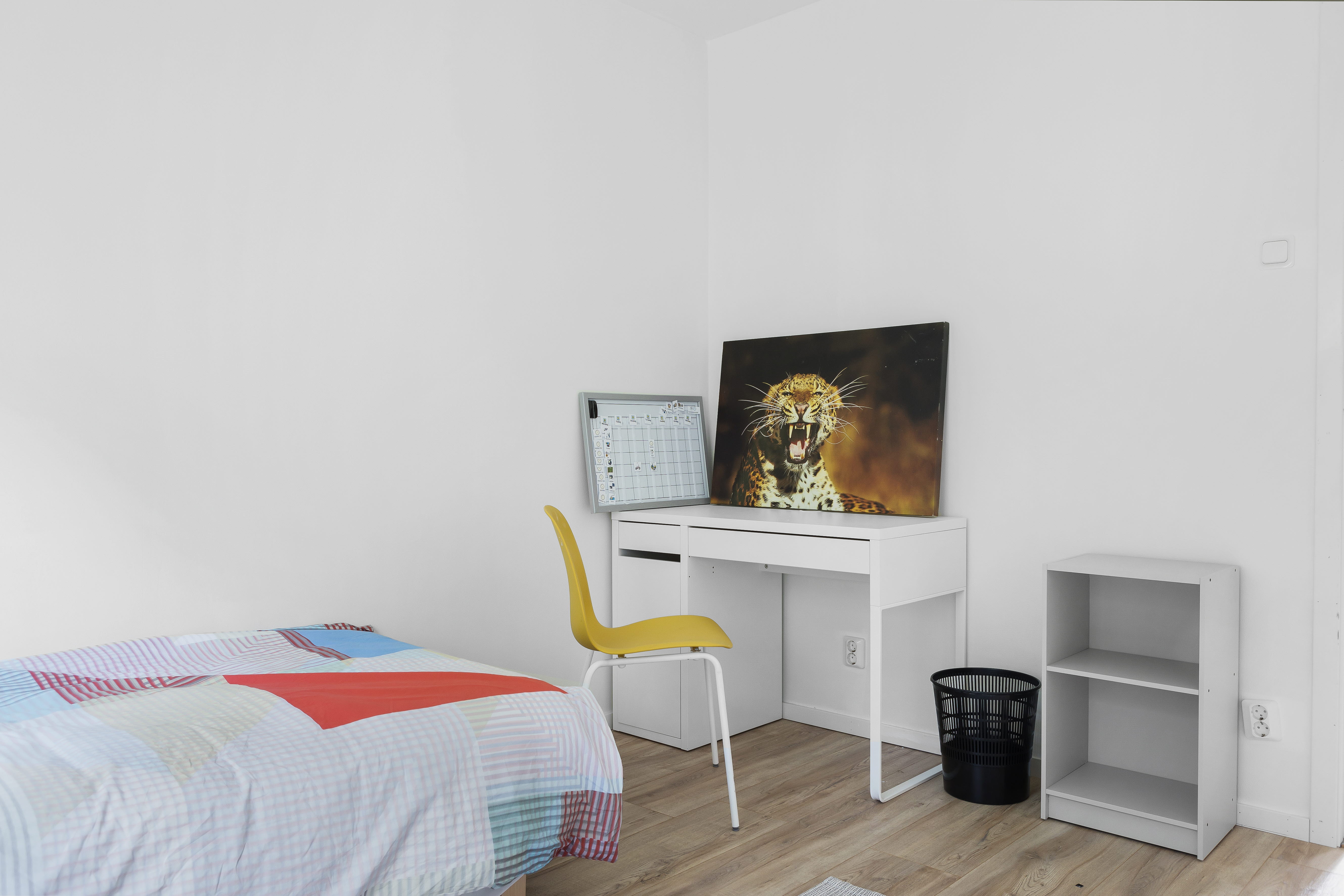 A bedroom with a bed in a room