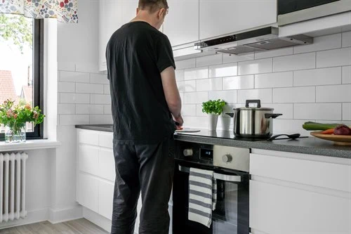 A person standing in a kitchen
