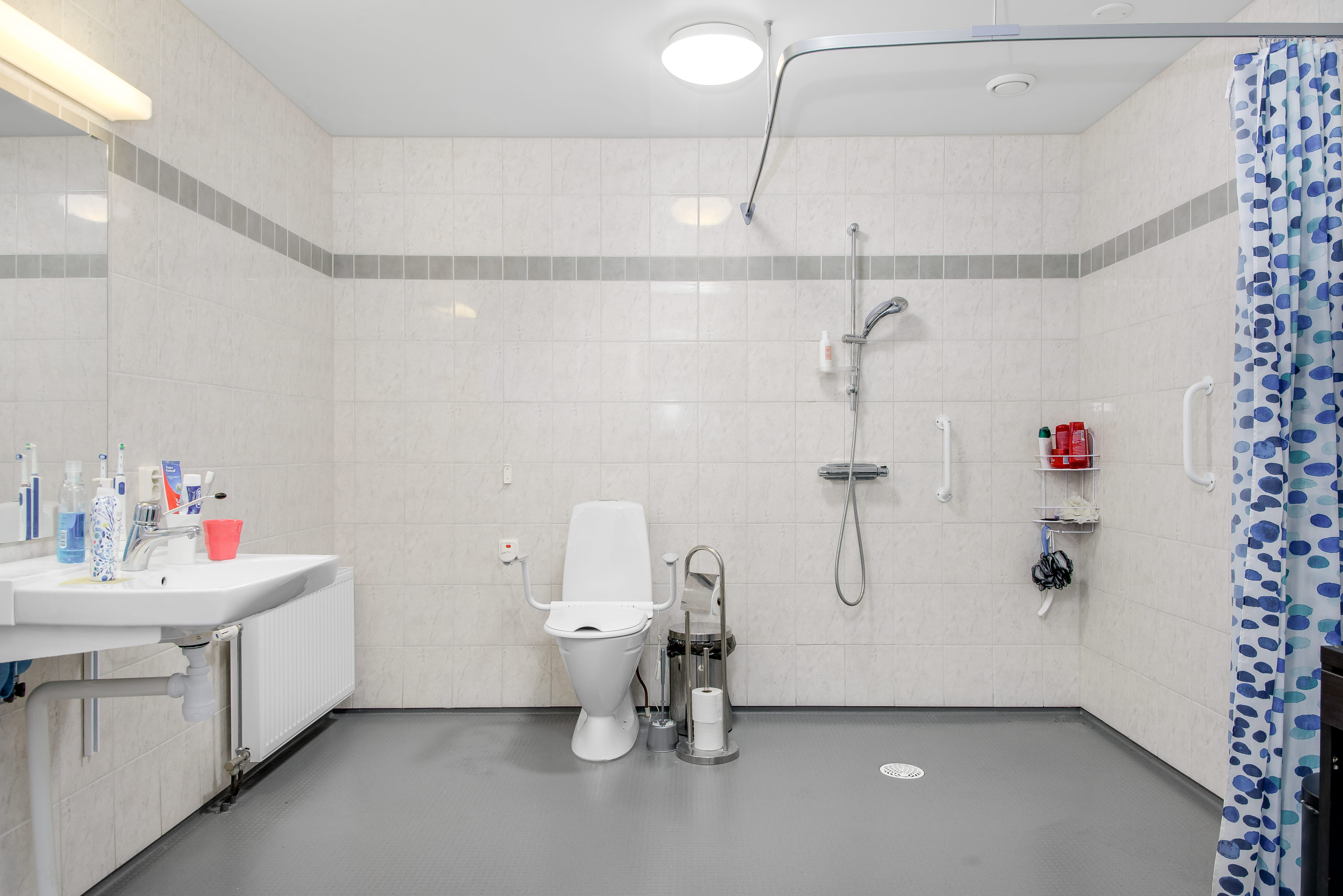 A room with a sink and a shower