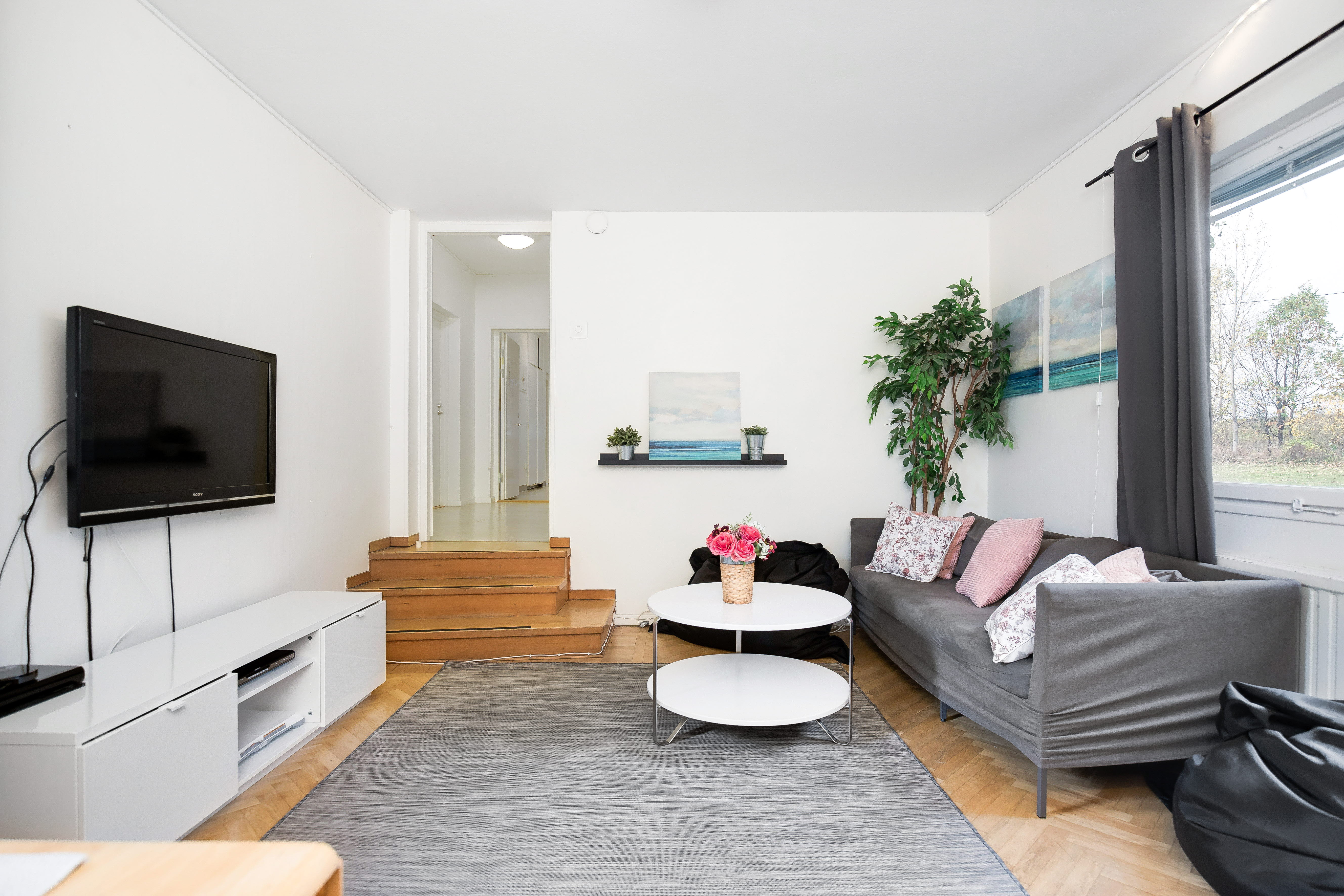 A living room filled with furniture and a large window