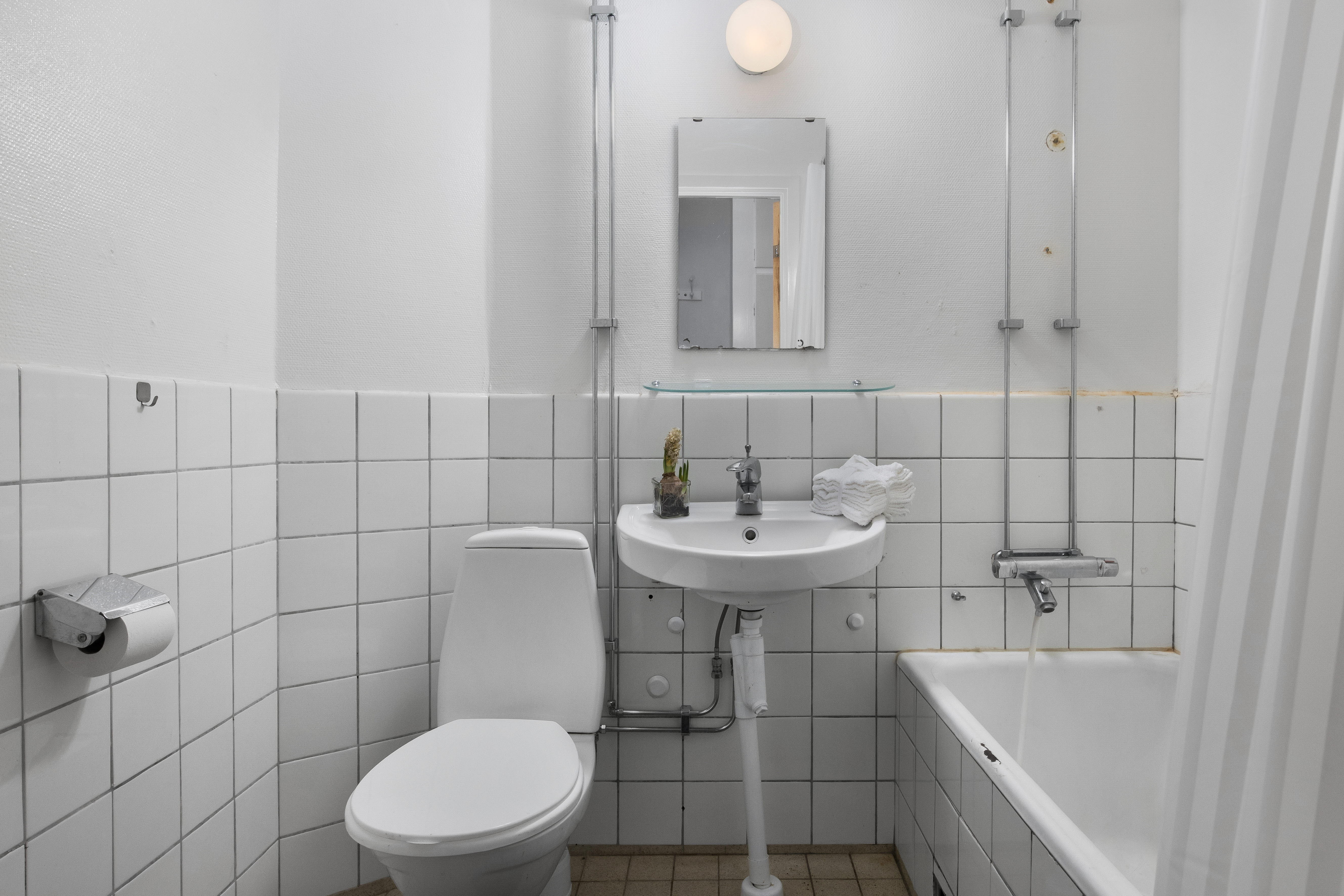 A room with a sink and a mirror