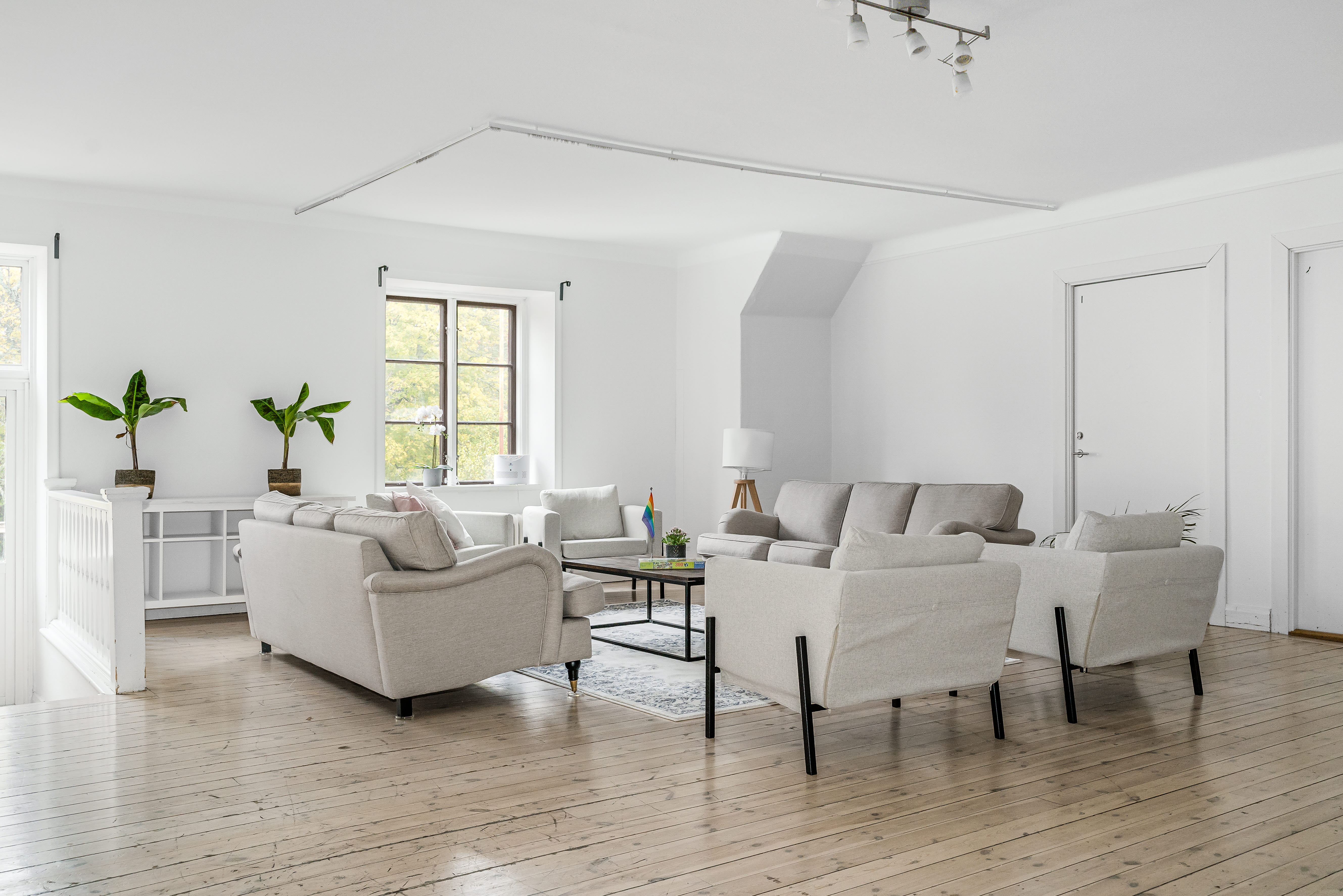 A living room with a wooden floor