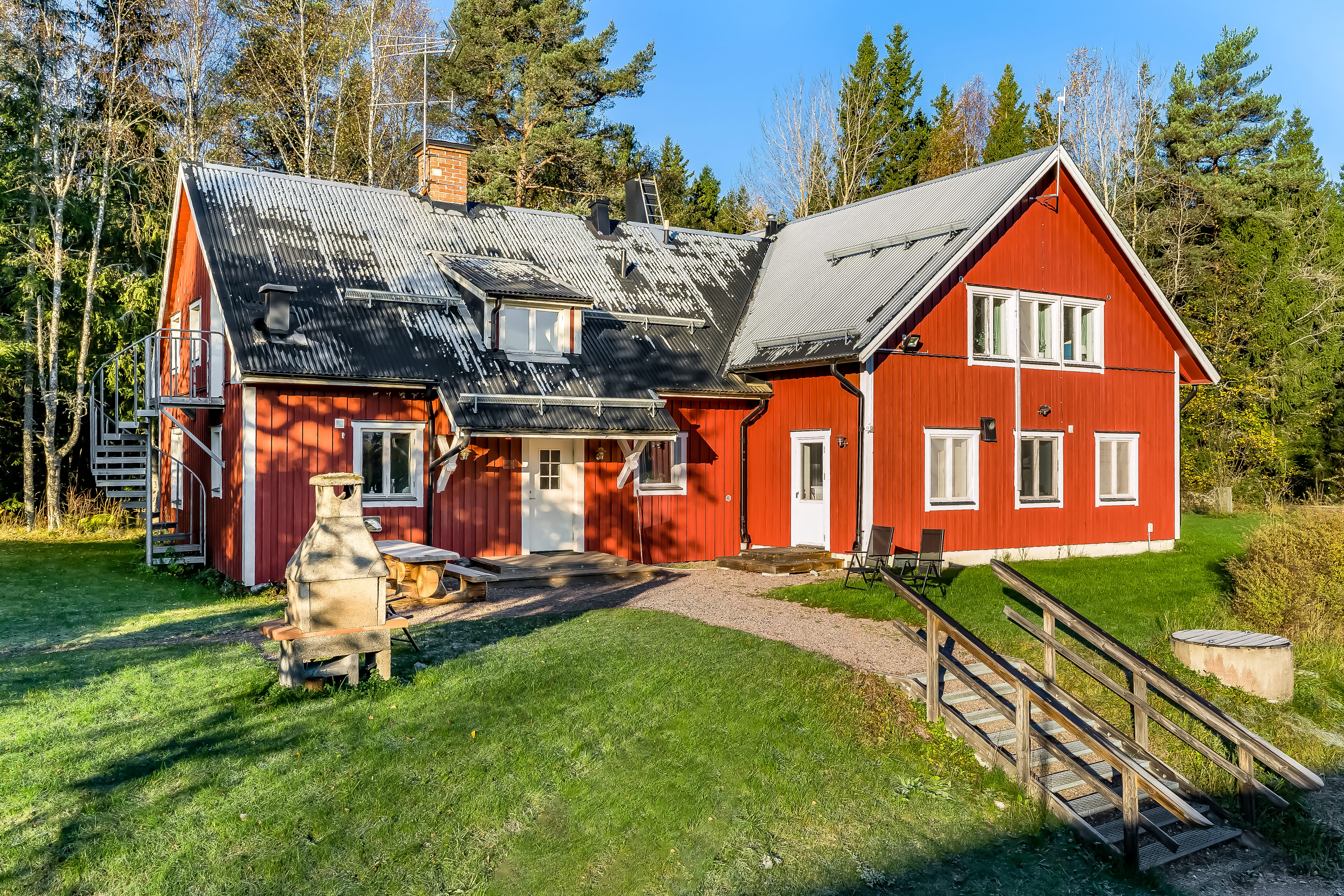 An old barn in front of a house